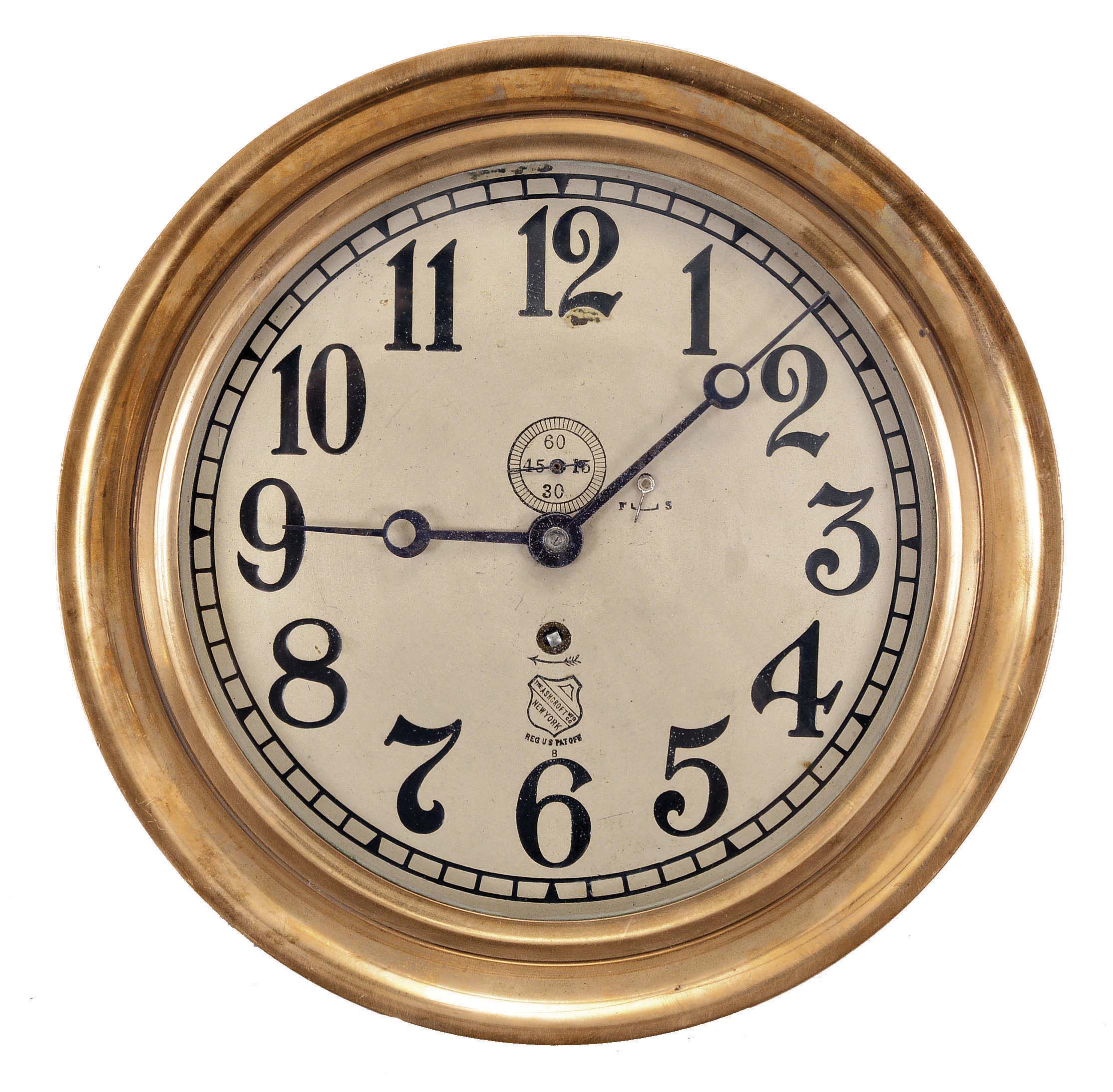Chelsea Clock Co., Boston, Mass., for The Ashcroft Mfg. Co., New York, engine room clock, 8 day, time only, spring-driven jeweled balance wheel movement in a brass case with hinged bezel, 8 inch silvered dial with Arabic numerals, the Ashcroft trademark, and subsidiary seconds, blued steel hands. — Antique Clocks Price Guide