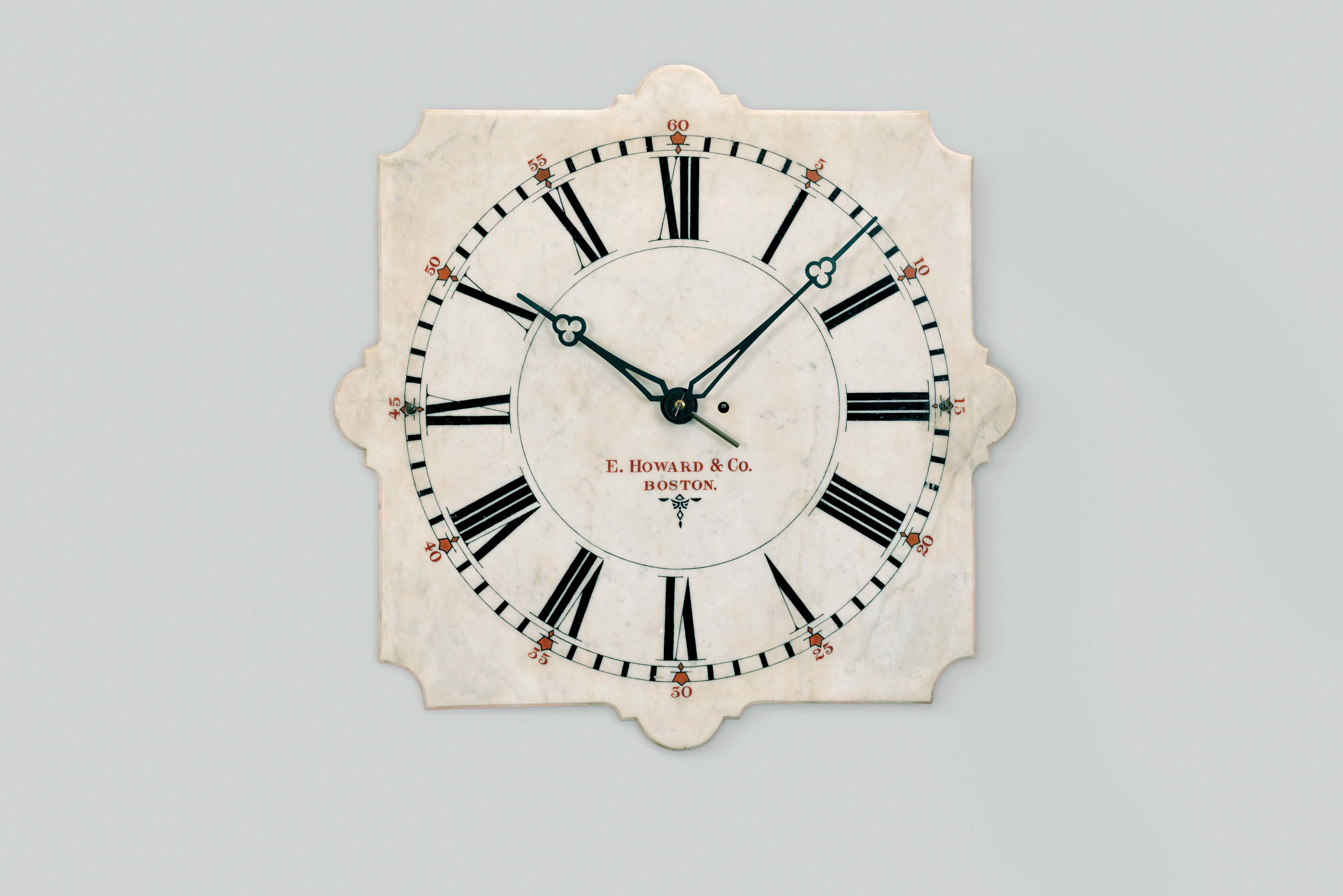 E. Howard &amp; Co., Boston, Mass., "Marble Dial No. 20" wall clock, 8 day, time only, weight driven movement with maintaining power in white painted wood case with 24 inch white marble dial, black painted chapter ring and Roman numerals with red arabic five minute markers, signed "E. Howard &amp; Co. / Boston" in red below the center arbor, black trefoil hands. — Antique Clocks Price Guide