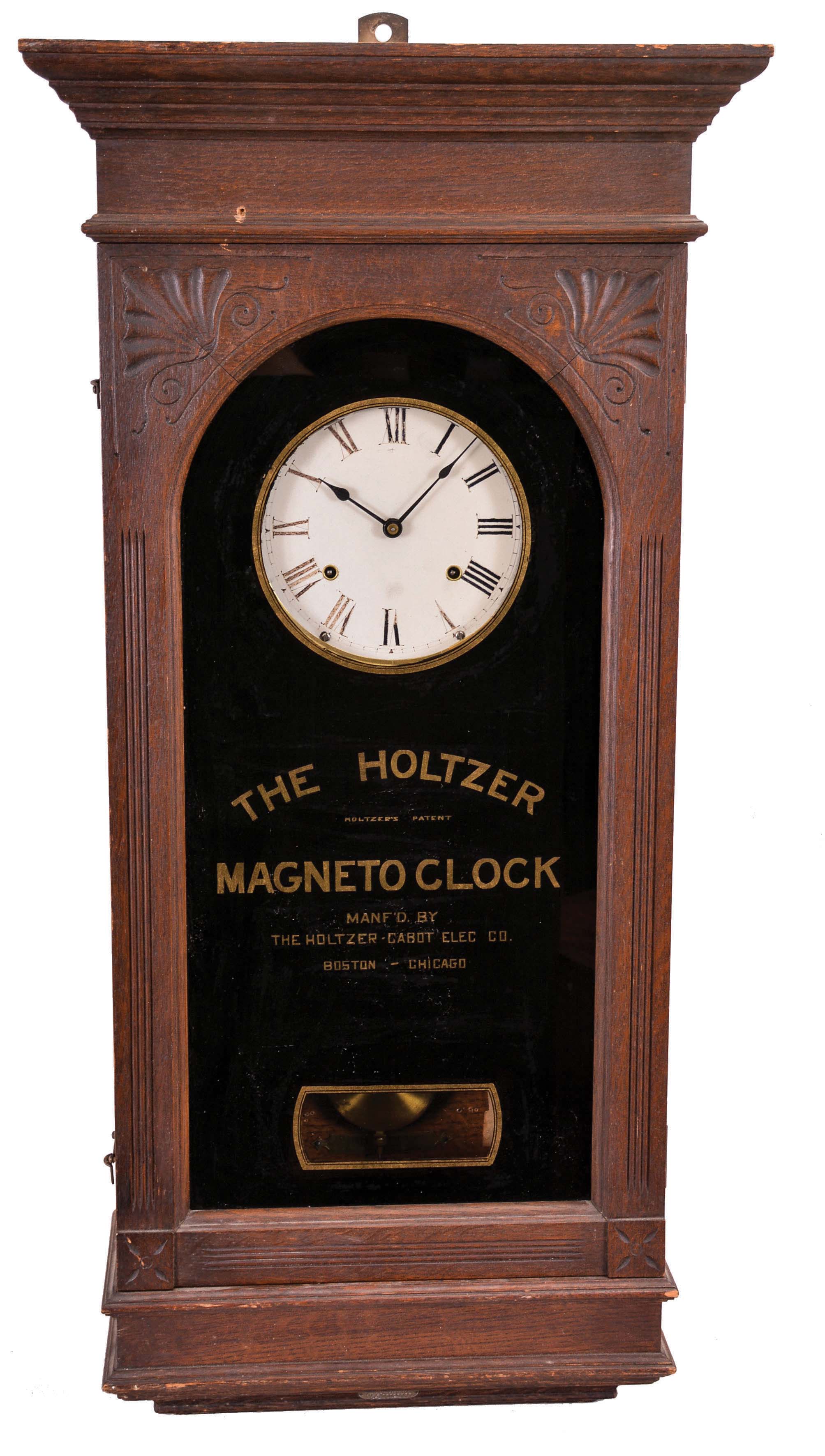 Holtzer-Cabot Co., Boston, Mass., "Holtzer Magneto Clock", 8 day, time and recorder function for 6 watchman's stations, twin-spring balance wheel movement for the time recorder and independent 8 day, twin-spring pendulum movement for the wall regulator, all in an oak case with black glass and gold leaf lettering with the name of the clock and manufacturer. — Antique Clocks Price Guide