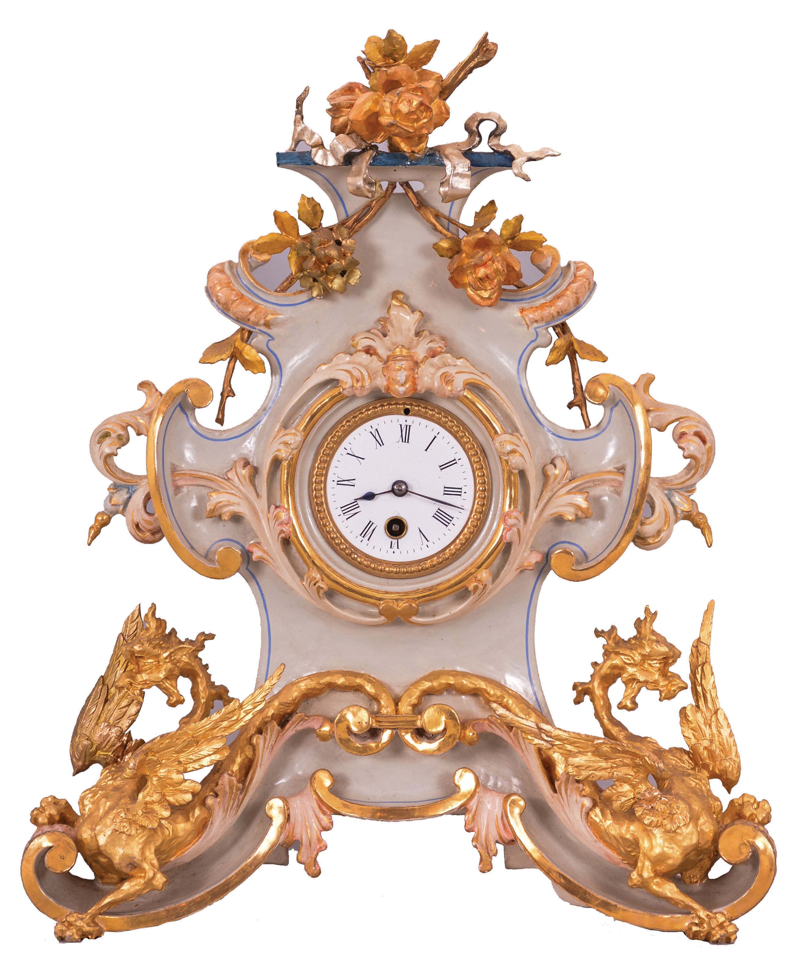 French mantel clock, the case and ornament of carved wood and finished to look like porcelain, with floral and rococo style ornament, and the base with winged dragons, with bright and matte gilding, gilt beaded bezel, Roman numeral white enamel dial, blued steel hands, 8 day, timepiece movement with pendulum — Antique Clocks Price Guide