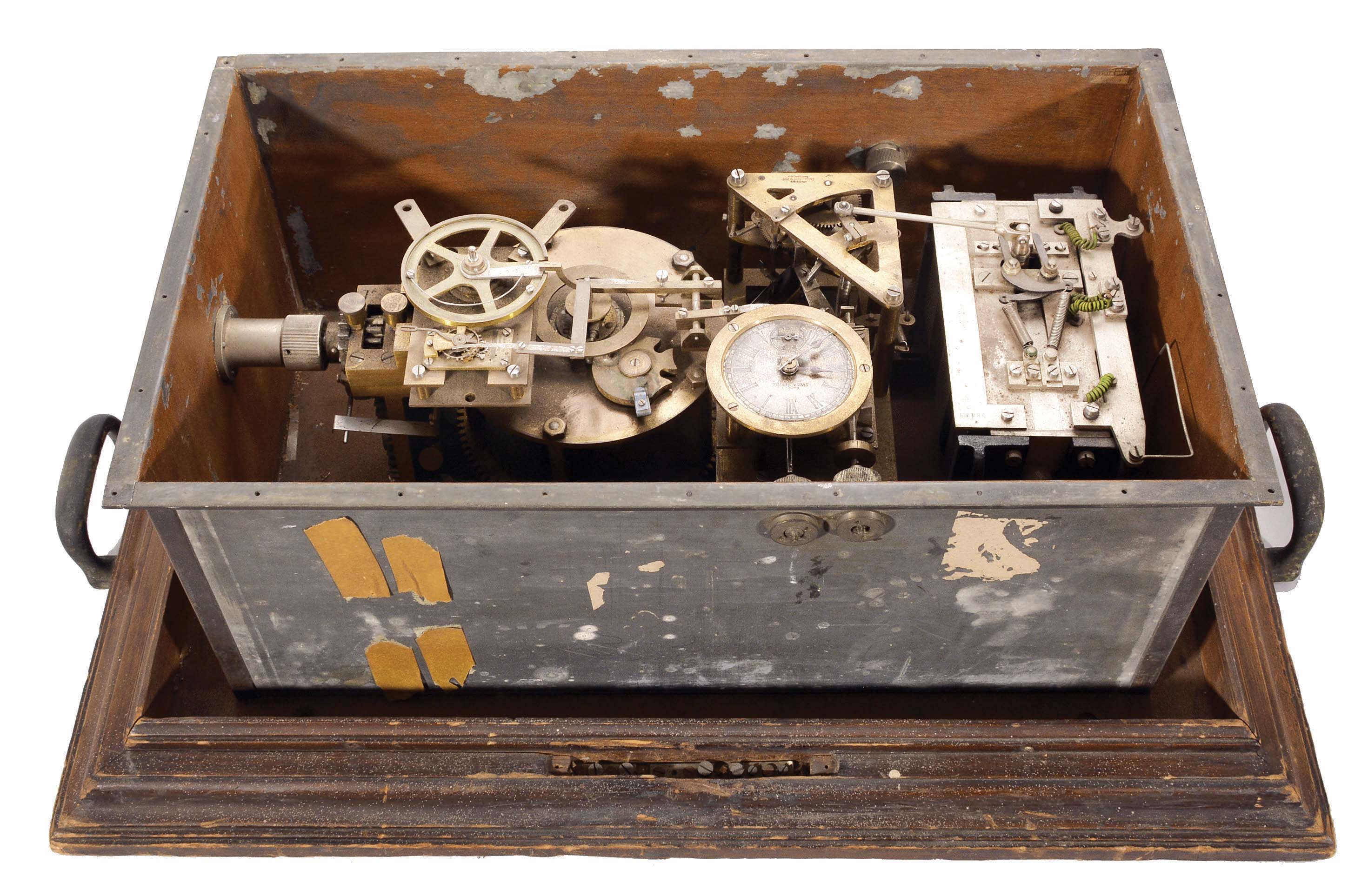 Magneta Time Co. Ltd., Zurich, Switzerland, Magneta Master Clock, 36 hour, time and magneto, spring-driven movement with two jeweled platforms, one with remontoir all in a four-sided metal enclosure with wood base, 2.5 inch signed silvered dial. — Antique Clocks Price Guide