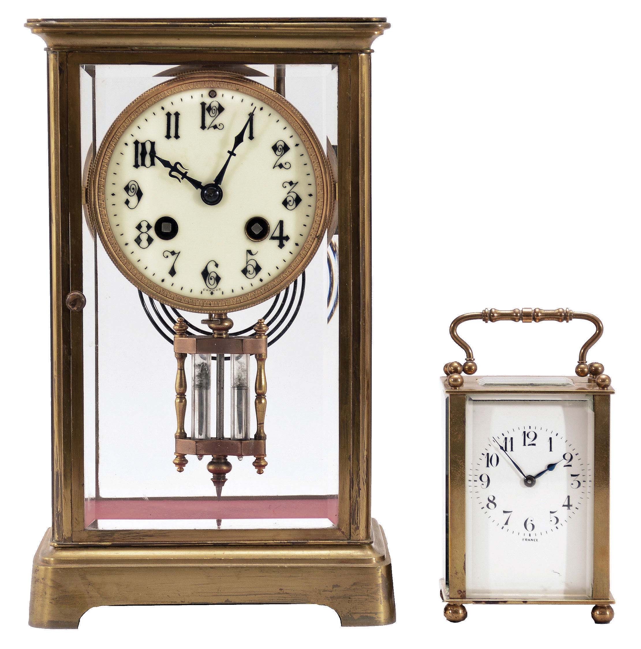 Clocks- 2 (Two) French Brass and Glass: (1) Japy Freres &amp; Cie., Paris, crystal regulator, 8 day, time and gong strike, spring-driven pendule de Paris movement with double-vial pendulum in a glazed case with beveled glasses, gilt brass corners, top and bottom, 3.5 inch cream porcelain dial with Arabic numerals and blued steel hands. (2) France, carriage clock, 8 day, time only, spring-driven movement in a glazed case with beveled glasses on five sides, polished brass case with handle on top, white enamel dial with Arabic numerals, and blued steel spade hands. — Antique Clocks Price Guide