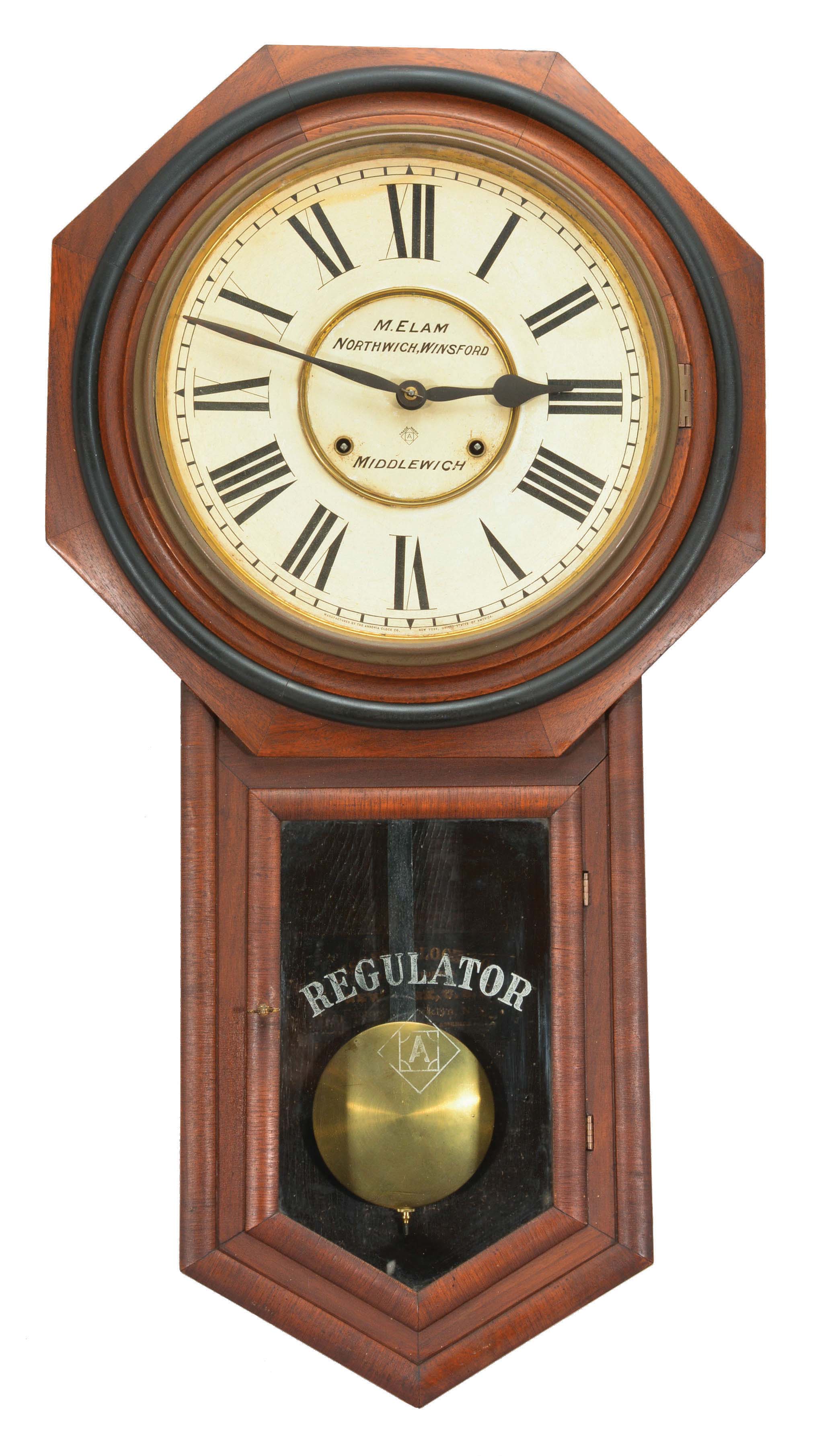 Clocks- 3 (Three) Drop Octagon: (1) Ansonia Clock Co., Brooklyn, New York, "Regulator A" wall clock, 8 day, time and strike, spring driven movement in a walnut veneered case with a papered metal dial reading "M. Elam / Northwich, Winsford / Middlewich", screened lower tablet reading "Regulator" with the Ansonia trademark, steel spade hands, c1900. (2) E.N. Welch Mfg. Co., Forestville, Conn., "Drop Octagon" wall clock, 8 day, time only, spring driven movement in a tiger stripe veneer case with a papered metal dial and maltese style hands, c1890. (3) E.N. Welch Mfg. Co., Bristol, Conn., "R.C. Drop Octagon" wall clock, 8 day, time only, spring driven movement in a rosewood veneer case with a painted metal dial and lance style steel hands, c1882. — Antique Clocks Price Guide
