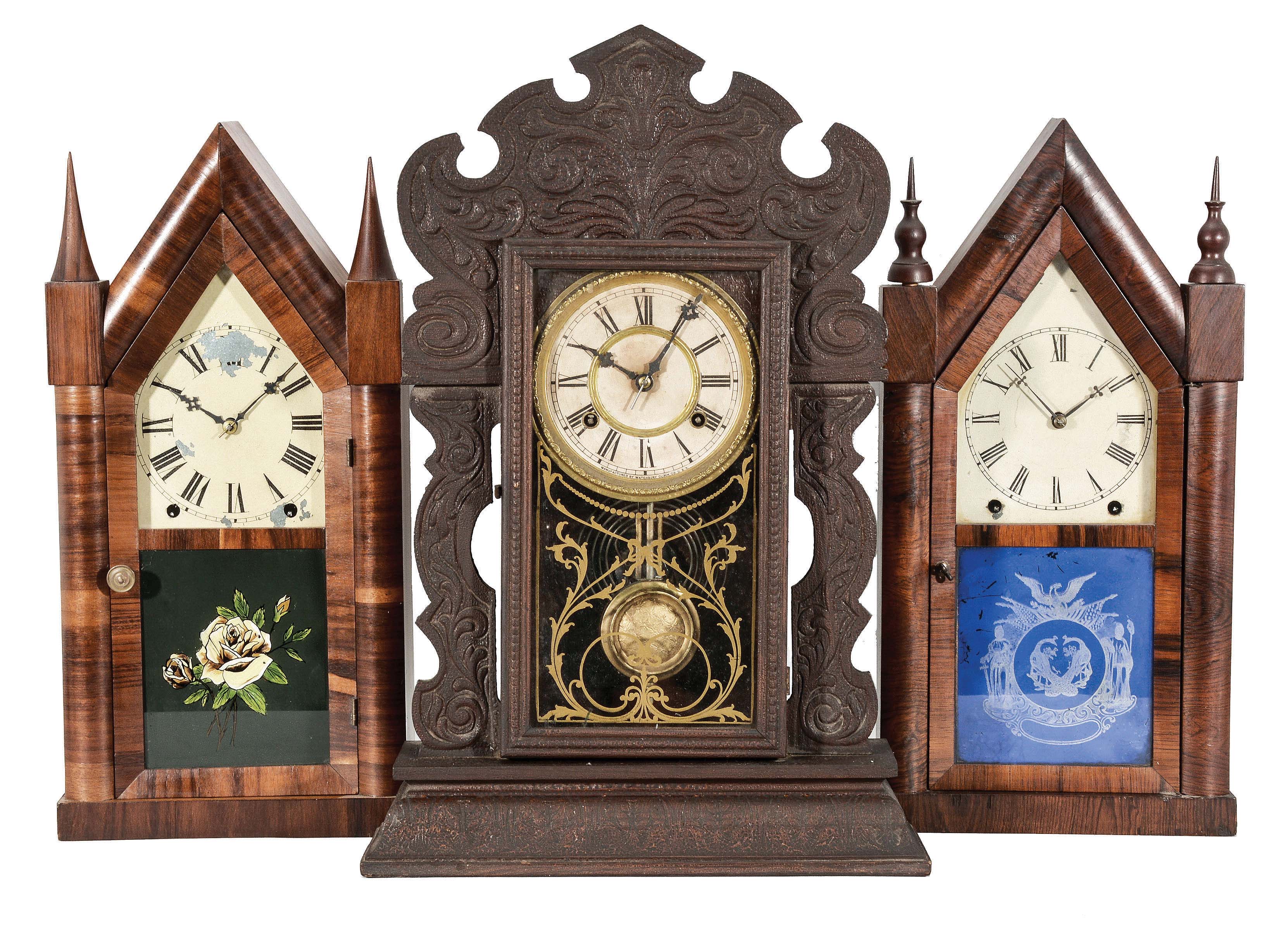 Clocks- 3 (Three) Mantel: (1) New Haven Clock Co., New Haven, Conn., sharp gothic or steeple clock, 8 day, time and strike, spring driven movement in a rosewood veneer case with a painted metal dial and silk screened door glass, blued steel hands, c1860. (2) E.N. Welch Mfg. Co., Forestville, Conn., sharp gothic or steeple clock, 8 day, time and bell strike, spring driven movement in a rosewood veneer case with a painted metal dial and silk screened door glass, maltese style hands, c1865. (3) Waterbury Clock Co., Waterbury, Conn., "Iroquois" mantel clock, 8 day, time and strike on cathedral gong, spring driven movement in a pressed oak case with a papered metal dial, silk screened door glass, and maltese hands, c1910. — Antique Clocks Price Guide