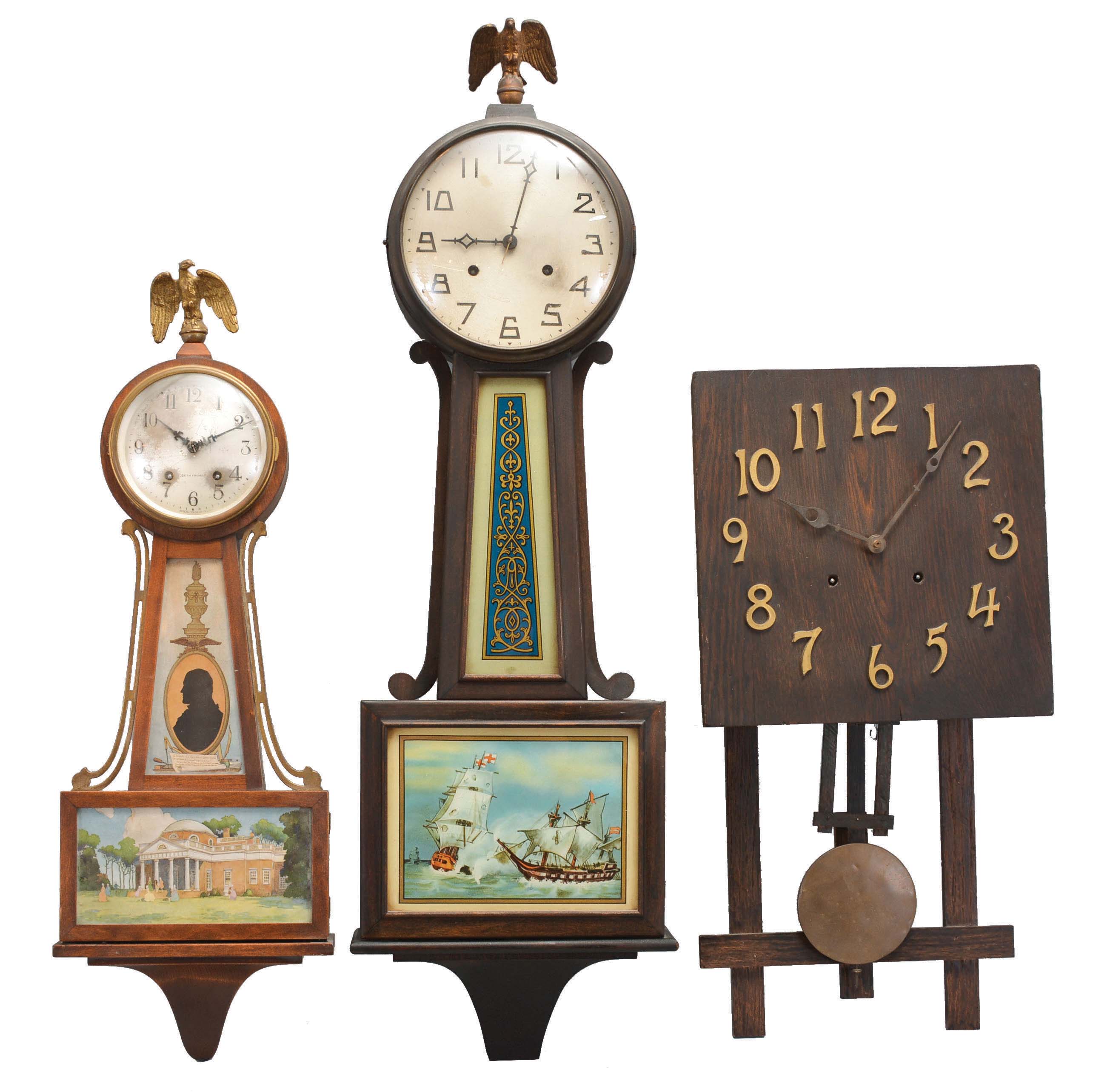 Clocks- 3 (Three) Time &amp; Strike Wall: (1) Seth Thomas Clock Co., Thomaston, Conn., "Banjo No. 7" wall clock, 8 day, time and strike, spring driven movement in a mahogany case with a silvered brass dial and tablets featuring Thomas Jefferson and Monticello, c1929. (2) New Haven Clock Co., New Haven, Conn., "Waring" banjo clock, 8 day, time and strike, spring driven movement in a mahogany finish case with a silvered brass dial and reverse painted throat and lower tablet, c1923. (3) Connecticut, Mission style wall clock, 8 day, time and strike, spring driven movement in a dark oak case with applied bronze numerals, brass clad pendulum bob, c1910. — Antique Clocks Price Guide