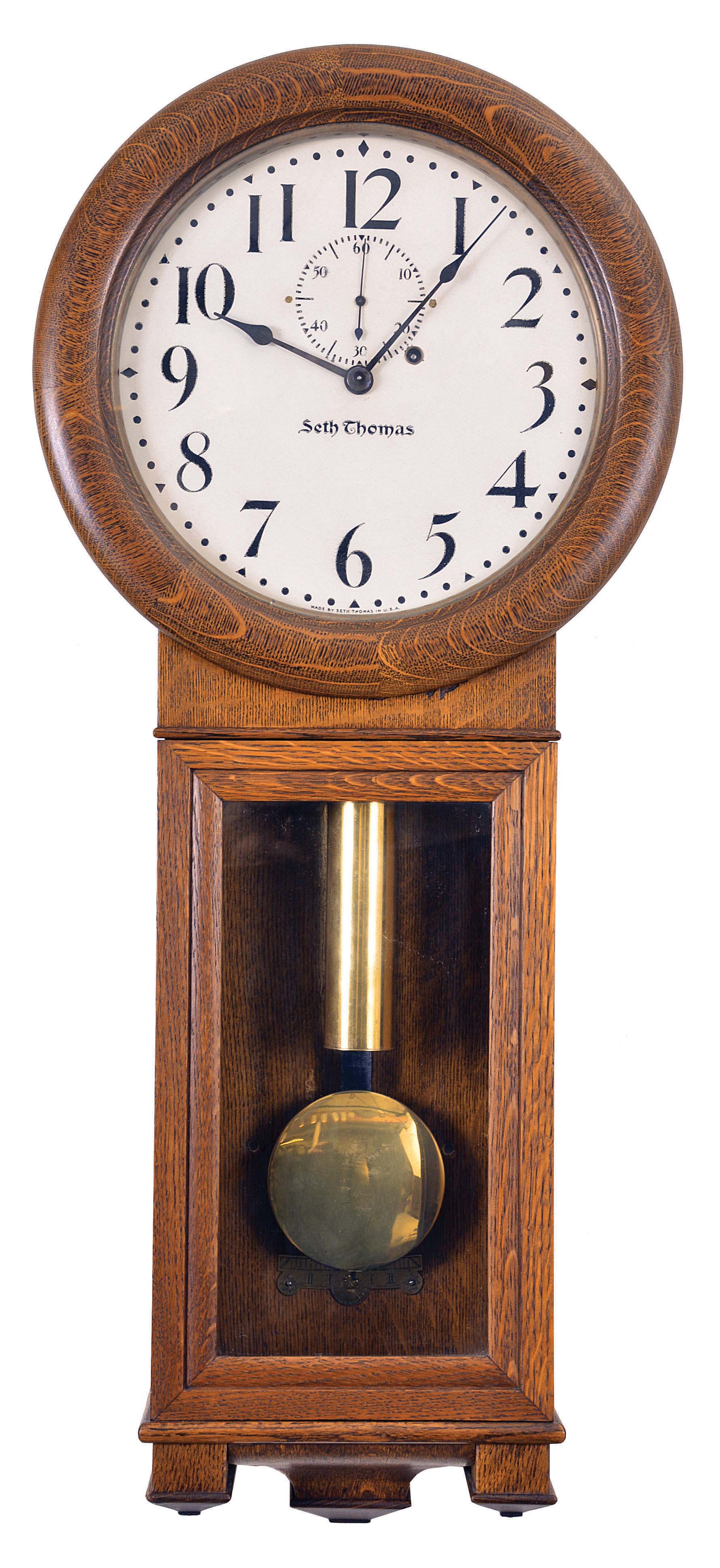 Seth Thomas Clock Co., Thomaston, Conn., "Office Regulator No. 2" hanging clock with a weight driven timepiece movement (77B) with maintaining power in an oak case. — Antique Clocks Price Guide