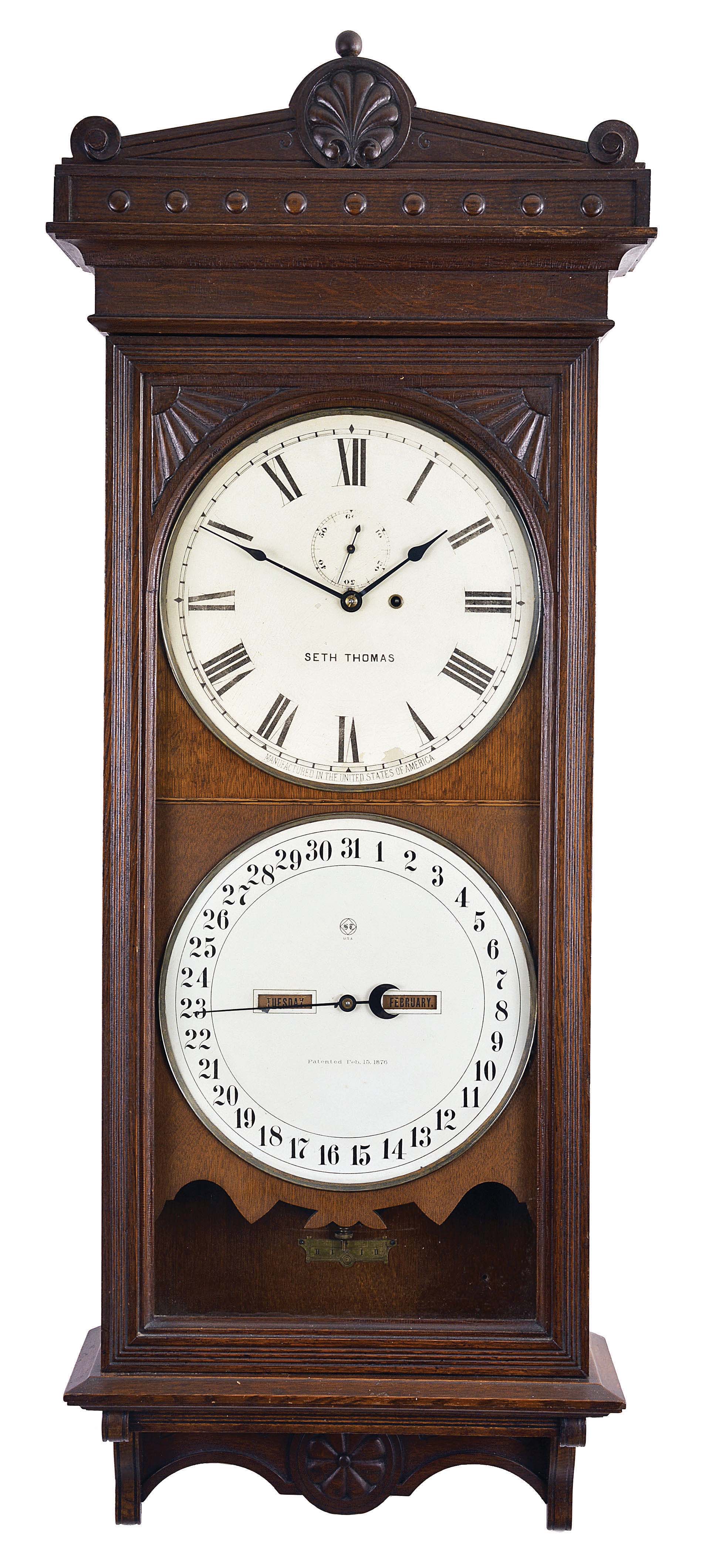 Seth Thomas Clock Co., Thomaston, Conn., "Office Calendar No. 13" hanging clock with a weight driven, 8 day, timepiece movement and an R. T. Andrews patented perpetual calendar mechanism in a solid oak case. — Antique Clocks Price Guide