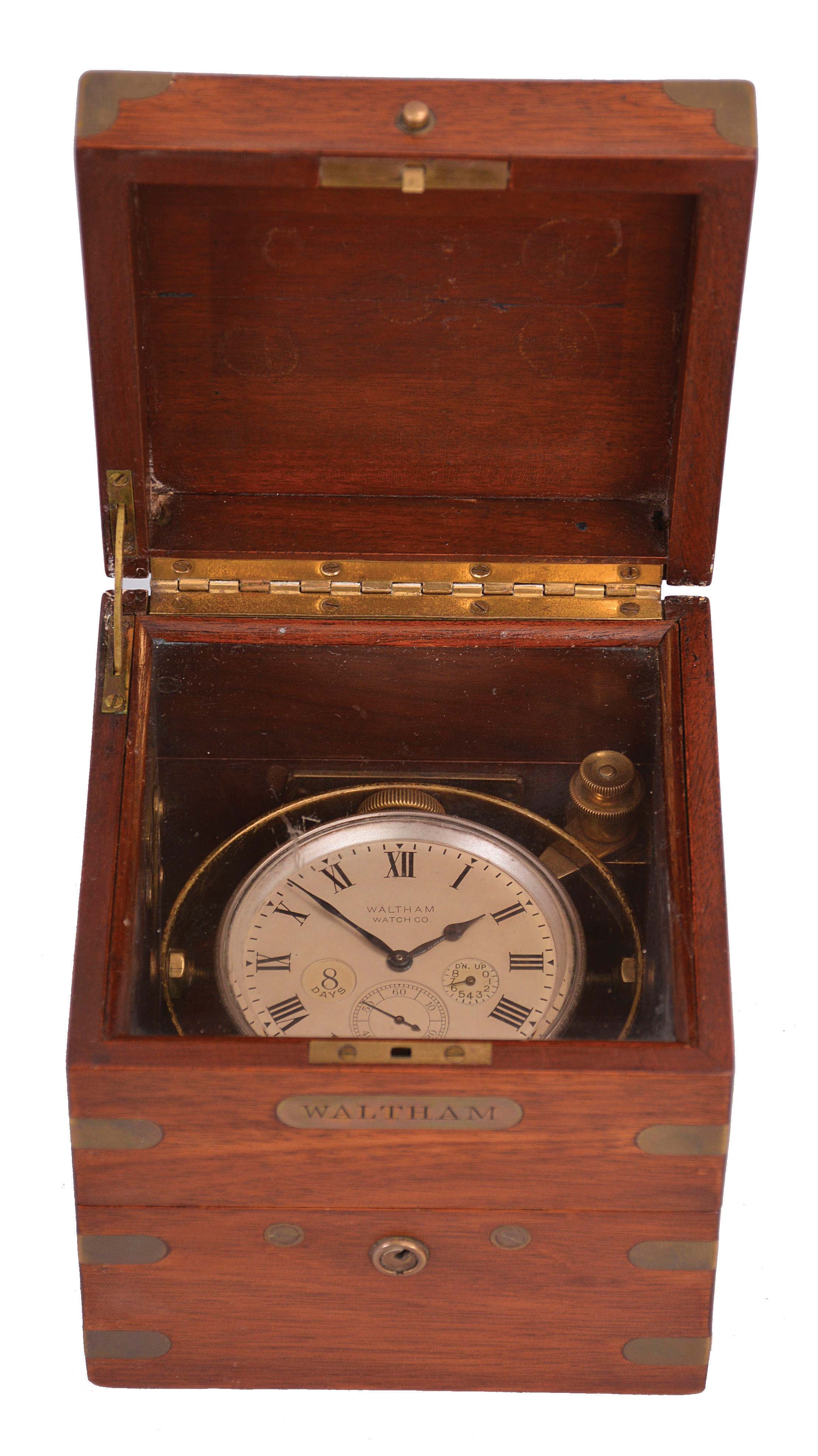 American Waltham Watch Co., Waltham, Mass., a boxed, 8 day deck watch with wind indicator, 37 size, 15 jewels, stem wind and set nickel plate movement, with Arabic numeral triple sunk dial, blued steel spade and poker hands, in a weighted brass tub with gimbals, all within a three tier mahogany box with brass furniture — Antique Clocks Price Guide