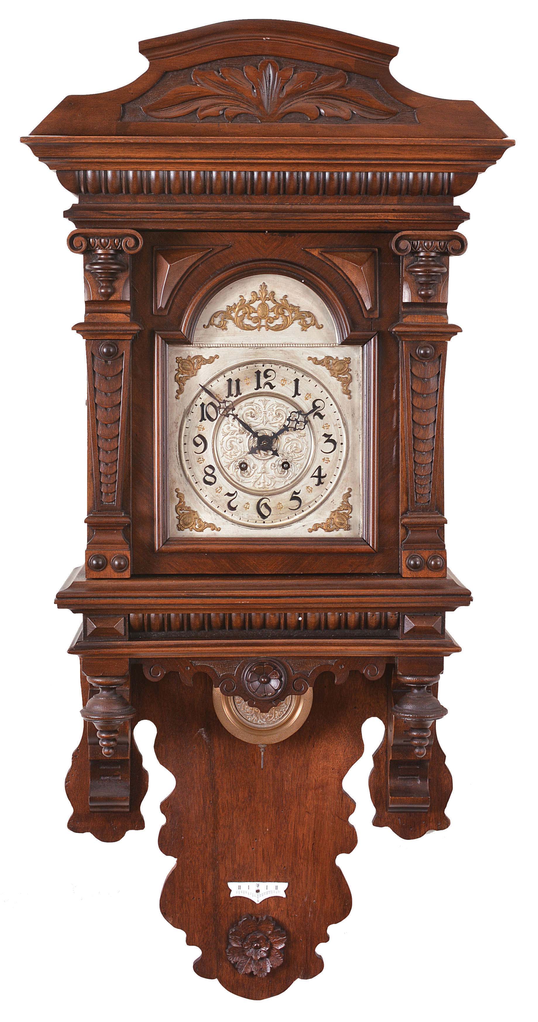 Gebrueder Wilde, Villingen, Germany, large "freischwinger", 8 day, time and gong strike, spring driven movement in a walnut case with carved acanthus on the crest and interesting pilasters flanking the door glass, silvered dial with Arabic numerals and pierced blued steel hands. — Antique Clocks Price Guide