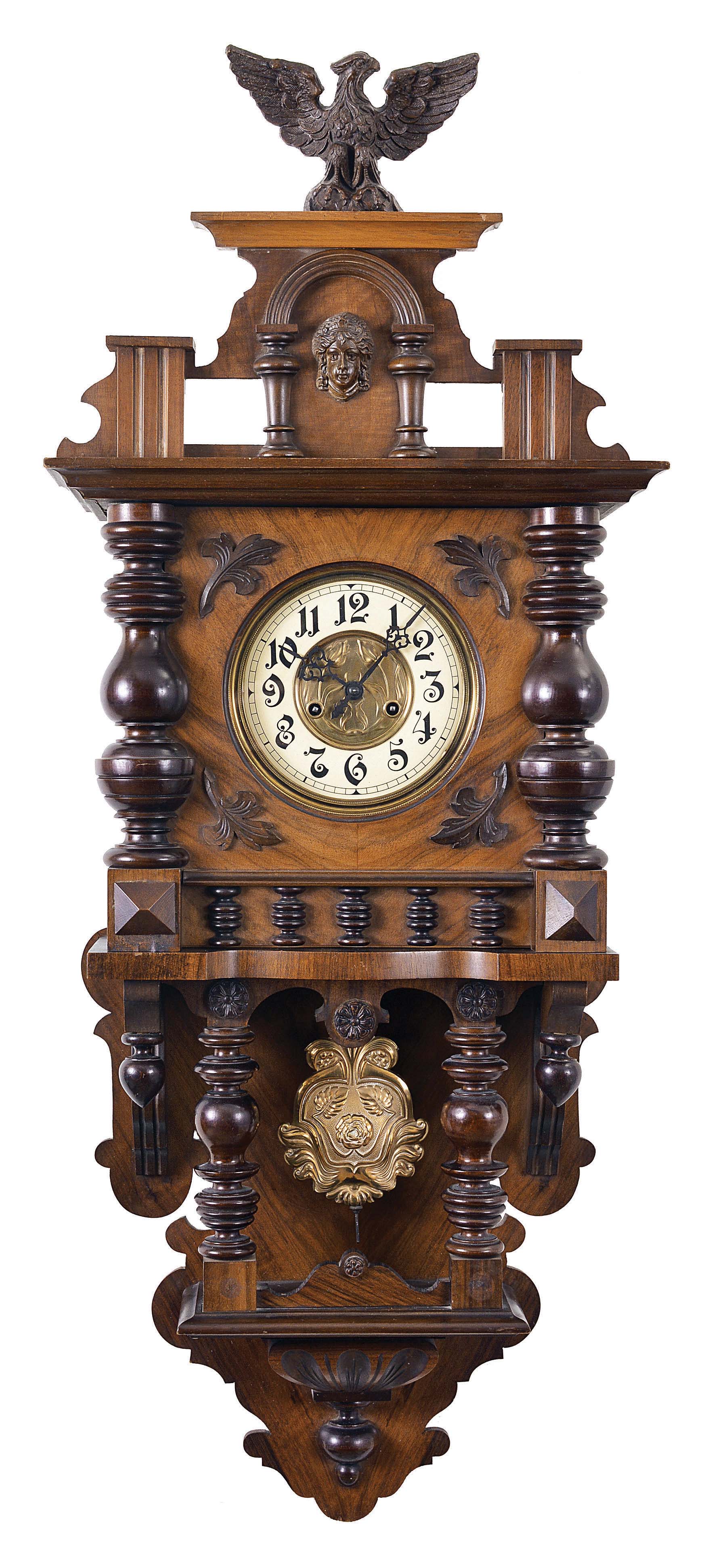 Clocks- 2 (Two) Becker Freischwingers: (1) Gustav Becker, Freiberg, Germany, freischwinger wall clock, 8 day, time and gong strike, spring driven movement in an walnut veneered Altdeutsch style case, c1890. (2) Kienzle, Schwenningen, Germany, freischwinger, 8 day, time and gong strike, spring driven movement in a walnut veneered Altdeutsch style case, c1910. — Antique Clocks Price Guide
