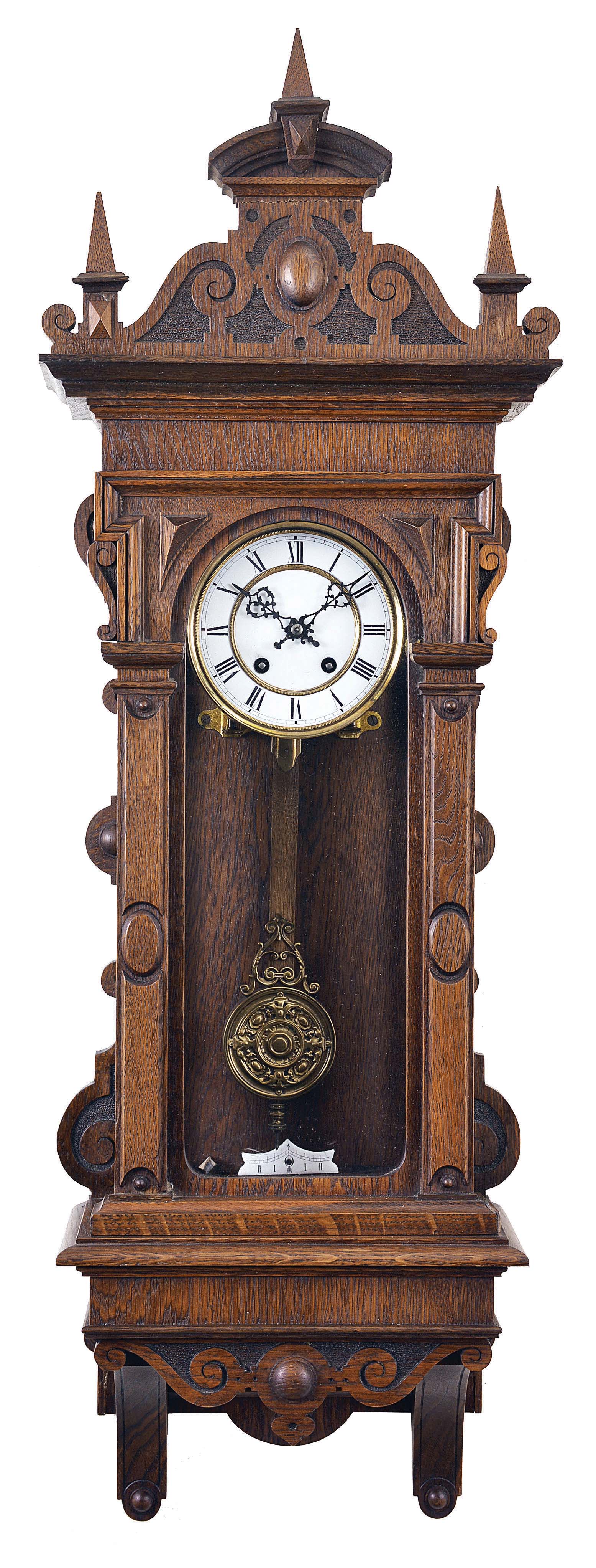 Lenzkirch Clock Co., Germany, "Nr. 564" wall clock, 8 day, time and strike, spring driven movement with deadbeat escapement in an oak Altdeutsch case with cast brass pendulum, white enamel dial, and pierced steel hands. — Antique Clocks Price Guide