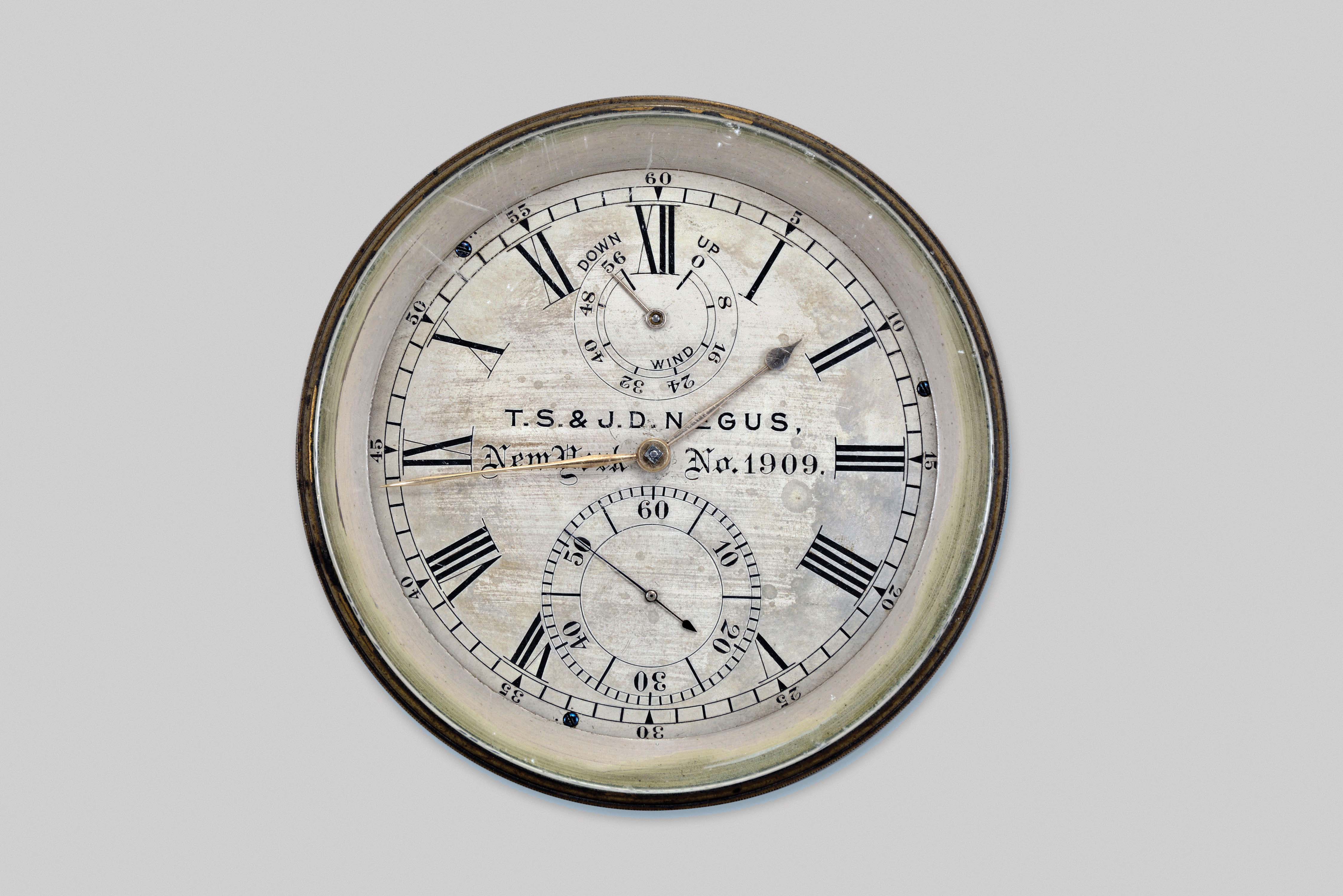 T.S. &amp; J.D. Negus, New York, two day marine chronometer, 11 jewel fusee movement with Earnshaw's escapement, freesprung, cut bimetallic balance, diamond endstone, and blued steel helical balance spring, the bottom plate with screw holes for break circuit contact, seconds arbor with additional wheel for break circuit mechanism, Roman numeral silvered dial with wind indicator and gold spade and poker hands, contained in a brass bowl, serial #1909, lacking box — Antique Clocks Price Guide