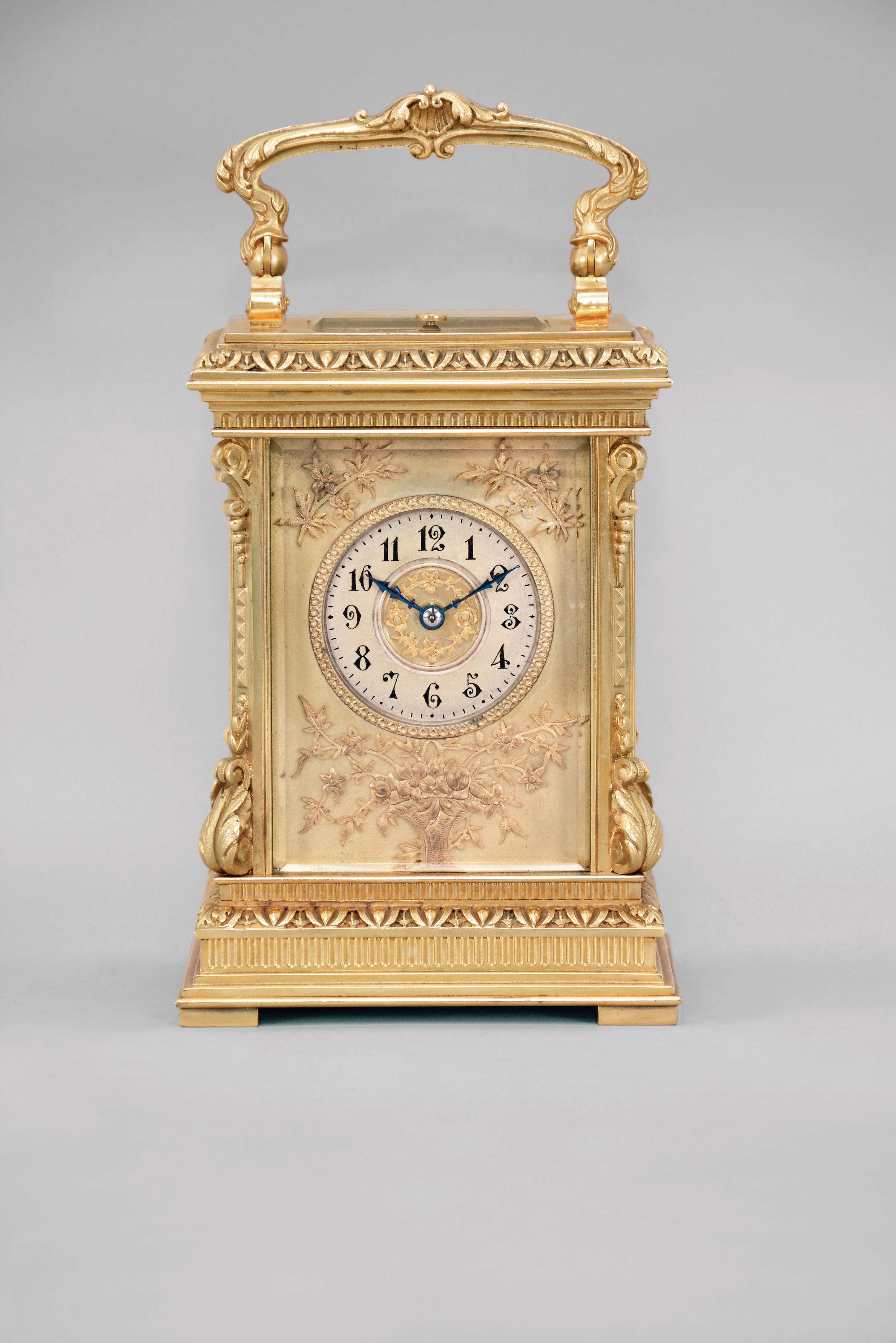 France, a highly ornamental and well executed hour repeating carriage clock, the gilt, Anglaise Riche variant case with stepped base below a fluted band and egg and dart molded surface canted corners ornamented with acanthus scroll bases and E scroll tops, supporting an entablature echoing the base, with fluted band, stepped cornice, and egg and dart cap, the top with folding handle decorated with acanthus and central scallop shell, all decorative ornament with fine chasing, Arabic numeral silvered dial with blued steel distaff hands, and gilt mat with applied, gilt floral ornaments, also finely chased, 8 day, two train movement with lever platform and cut bimetallic balance, striking the hour and half hour in passing, and repeating the last hour on demand — Antique Clocks Price Guide