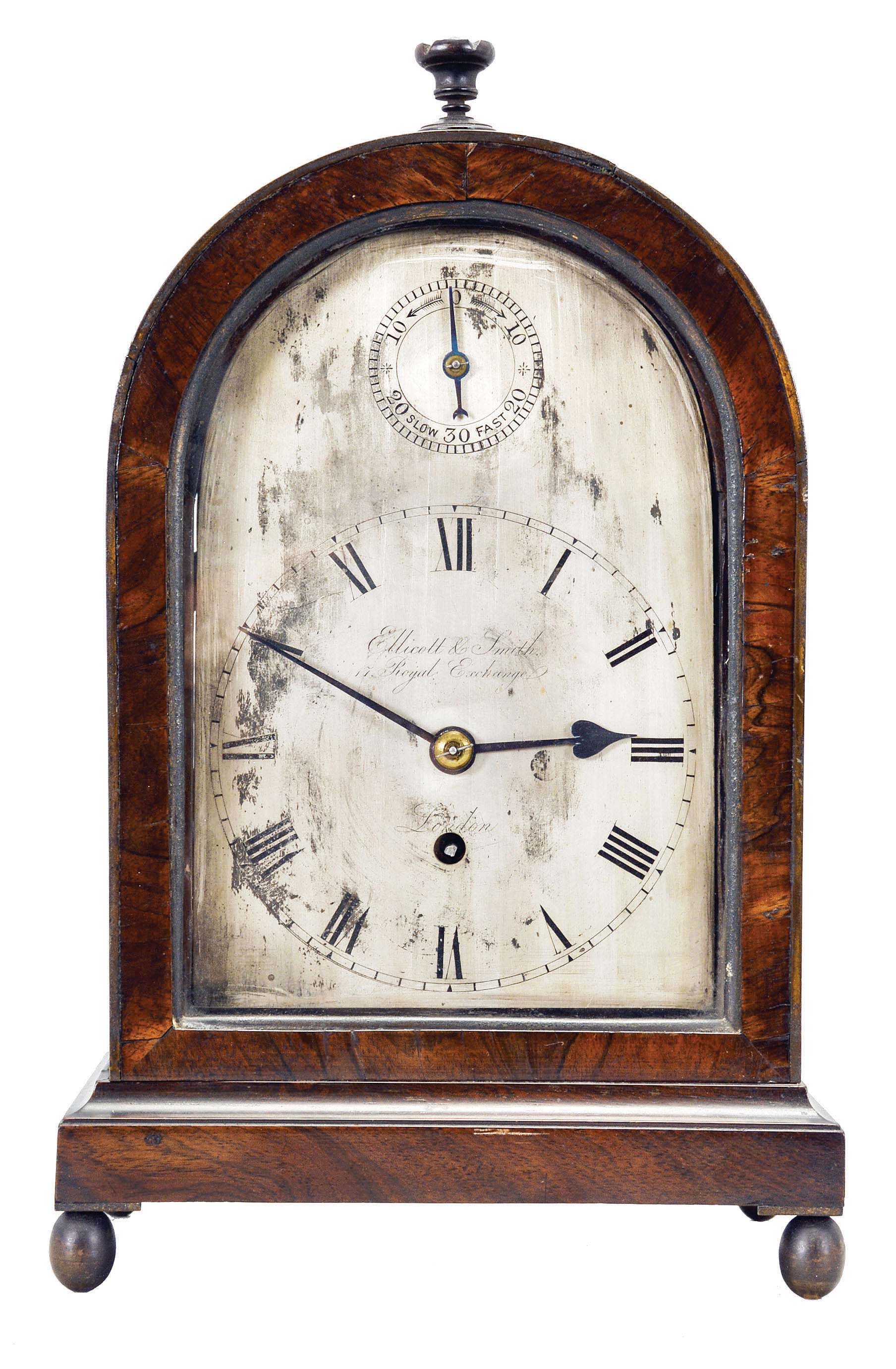 Ellicott and Smith, 17 Royal Exchange, London, a regency rosewood bracket timepiece, round top case with turned finial on a molded base with turned feet, sides with glazed, fish scale fret, signed Roman numeral silvered dial with blued steel hands and pointer for regulation, single train fusee movement with recoil escapement and rise and fall regulator, the back plate signed and with wheatear engraved border — Antique Clocks Price Guide