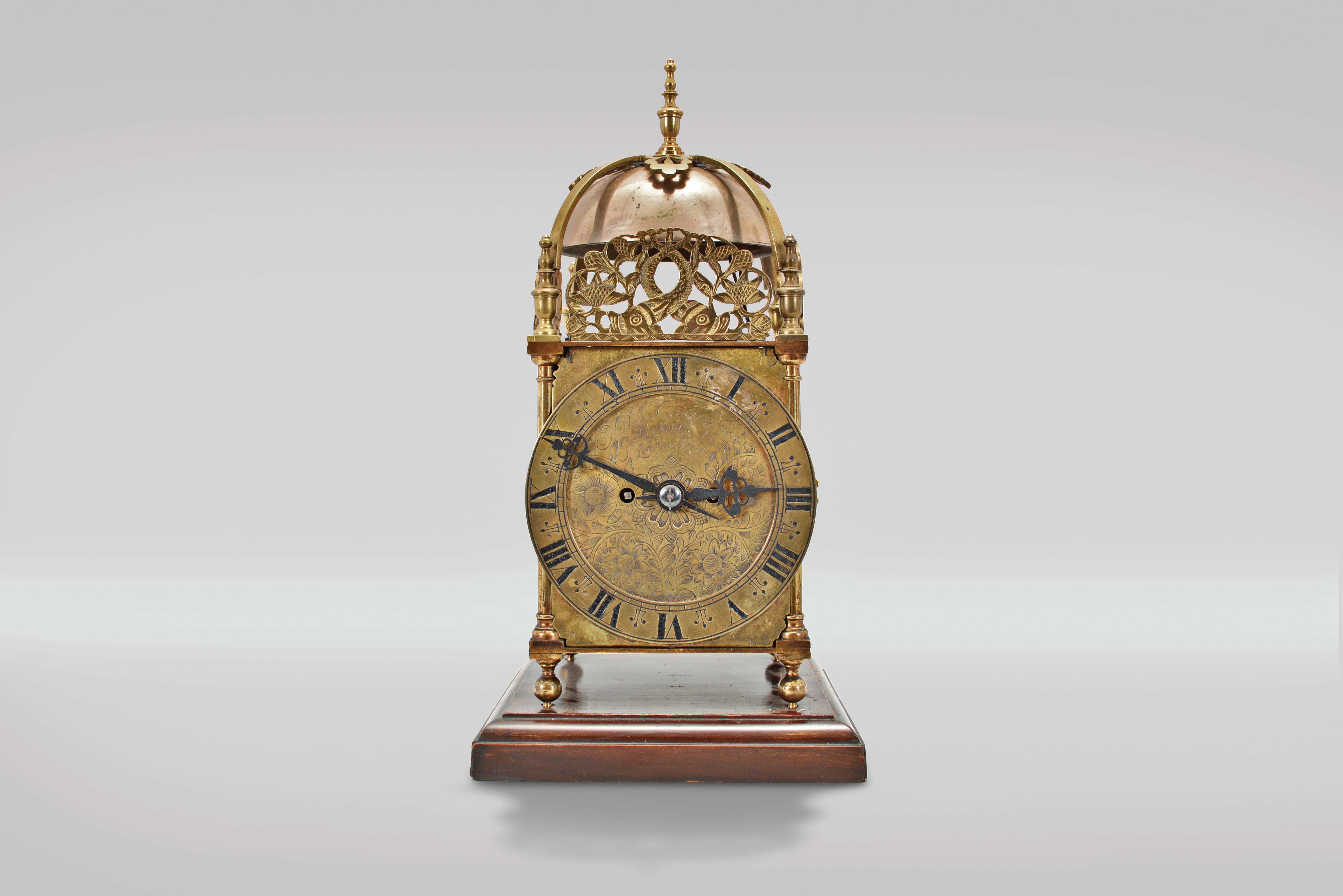 Payne &amp; Co., 163 New Bond St, London, a Victorian, quarter chiming lantern clock, 8 day duration, with walnut base, brass case with turned finials, columns and feet, Roman numeral engraved brass dial with pierced steel hands, top with pierced frets, the front fret with engraving, cast brass bell strap suspending two large bells, the two train fusee movement with recoil escapement, striking ting tang quarters on two bells, and the hours on the smaller bell, back plate signed, serial #5054 — Antique Clocks Price Guide