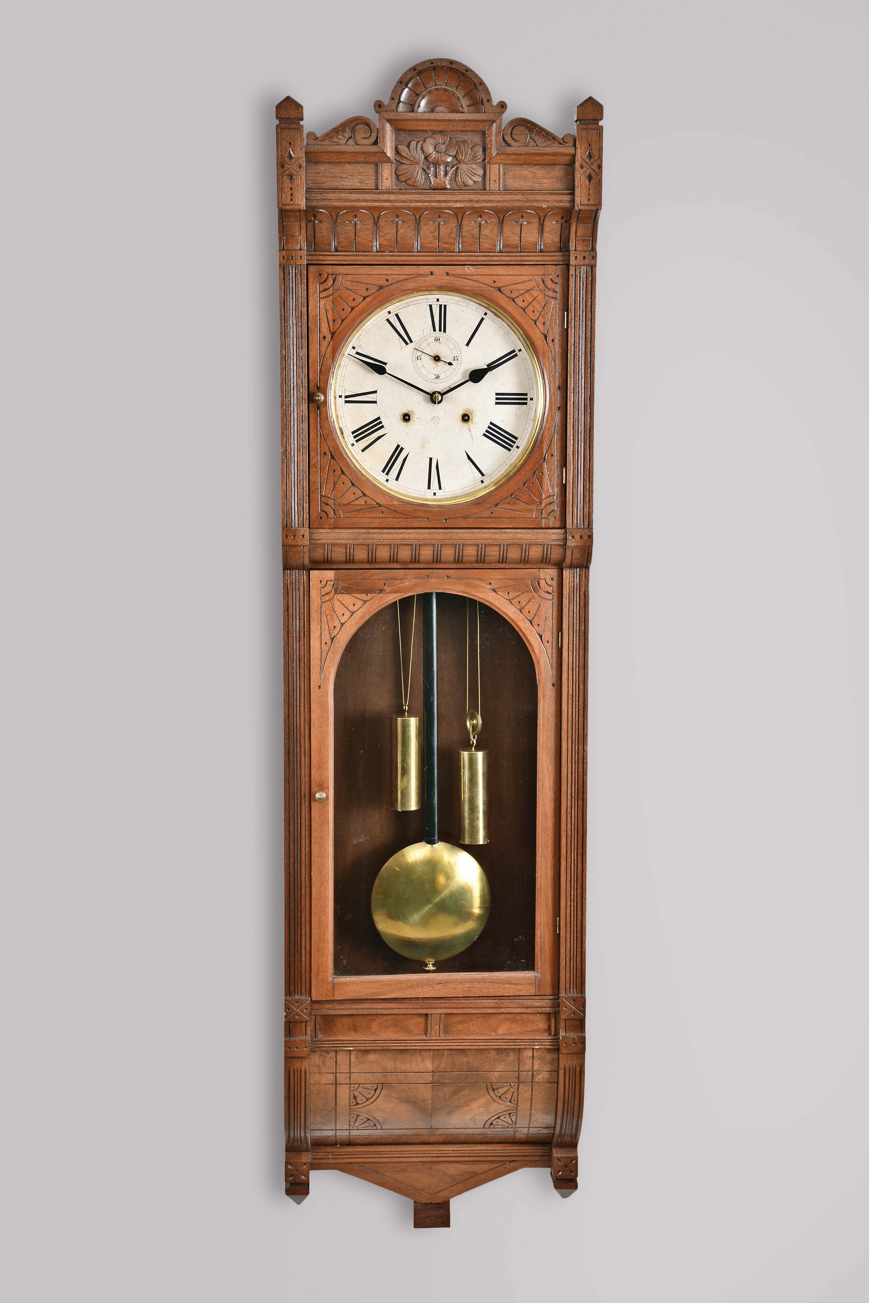 E. N. Welch Mfg. Co., Forestville, Conn., "Regulator E" hanging clock case now with an Ansonia 8 day double weight timepiece movement in a walnut case. — Antique Clocks Price Guide