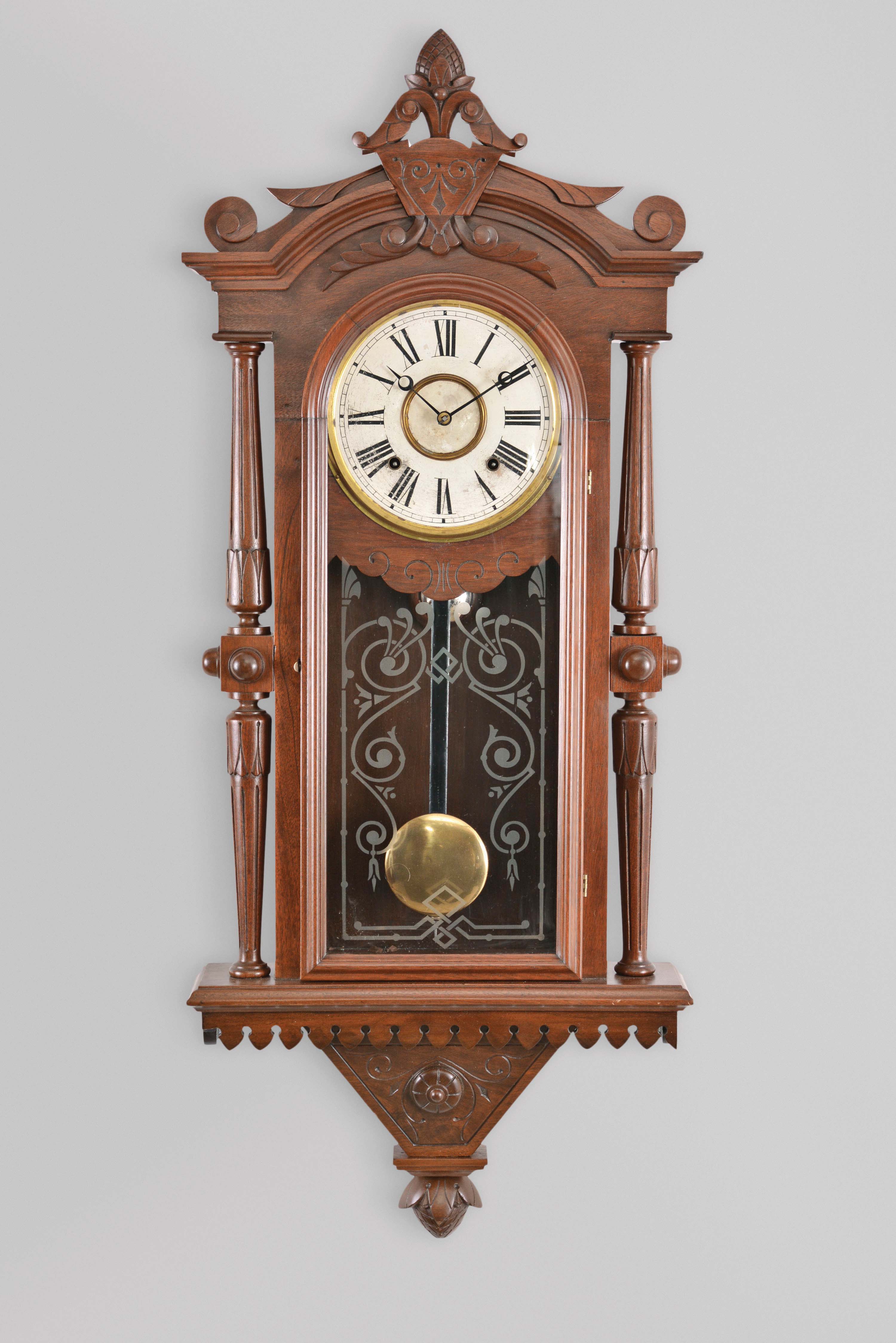 F. Kroeber Clock Co., New York, "Regulator No. 30" wall hanging clock with an E. N. Welch spring driven, 8 day, time and strike movement in a walnut case with burl accents. — Antique Clocks Price Guide