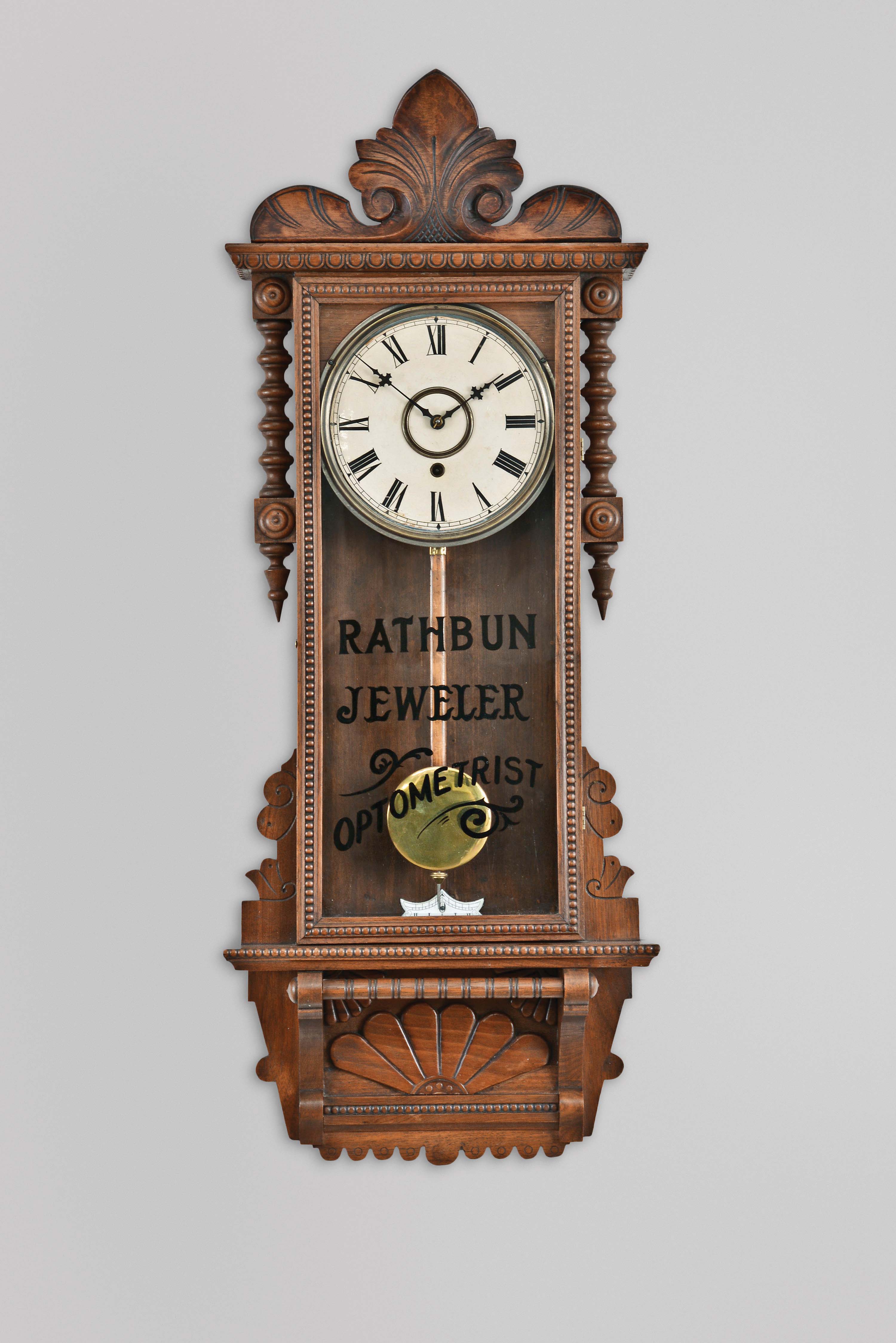 William L. Gilbert Clock Co., Winsted, Conn., "Newport" hanging clock with a spring driven, 8 day, timepiece movement in a walnut case. — Antique Clocks Price Guide