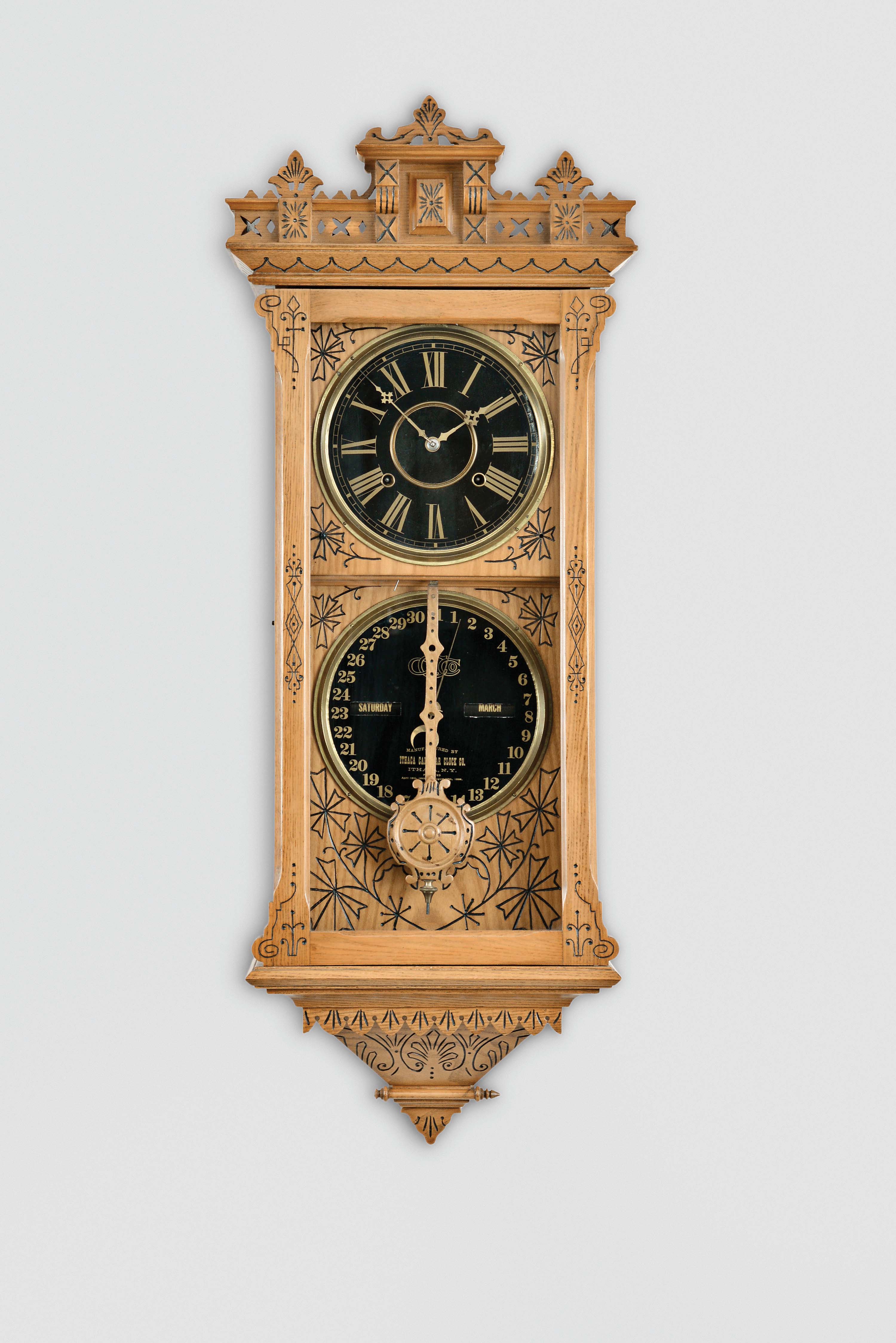 Ithaca Calendar Clock Co., Ithaca, New York, "No. 5 1/2, Hanging Belgrade" wall clock with an E. N. Welch spring driven, 8 day, time and strike movement and an H. B. Horton patented perpetual calendar mechanism in an ash case. — Antique Clocks Price Guide