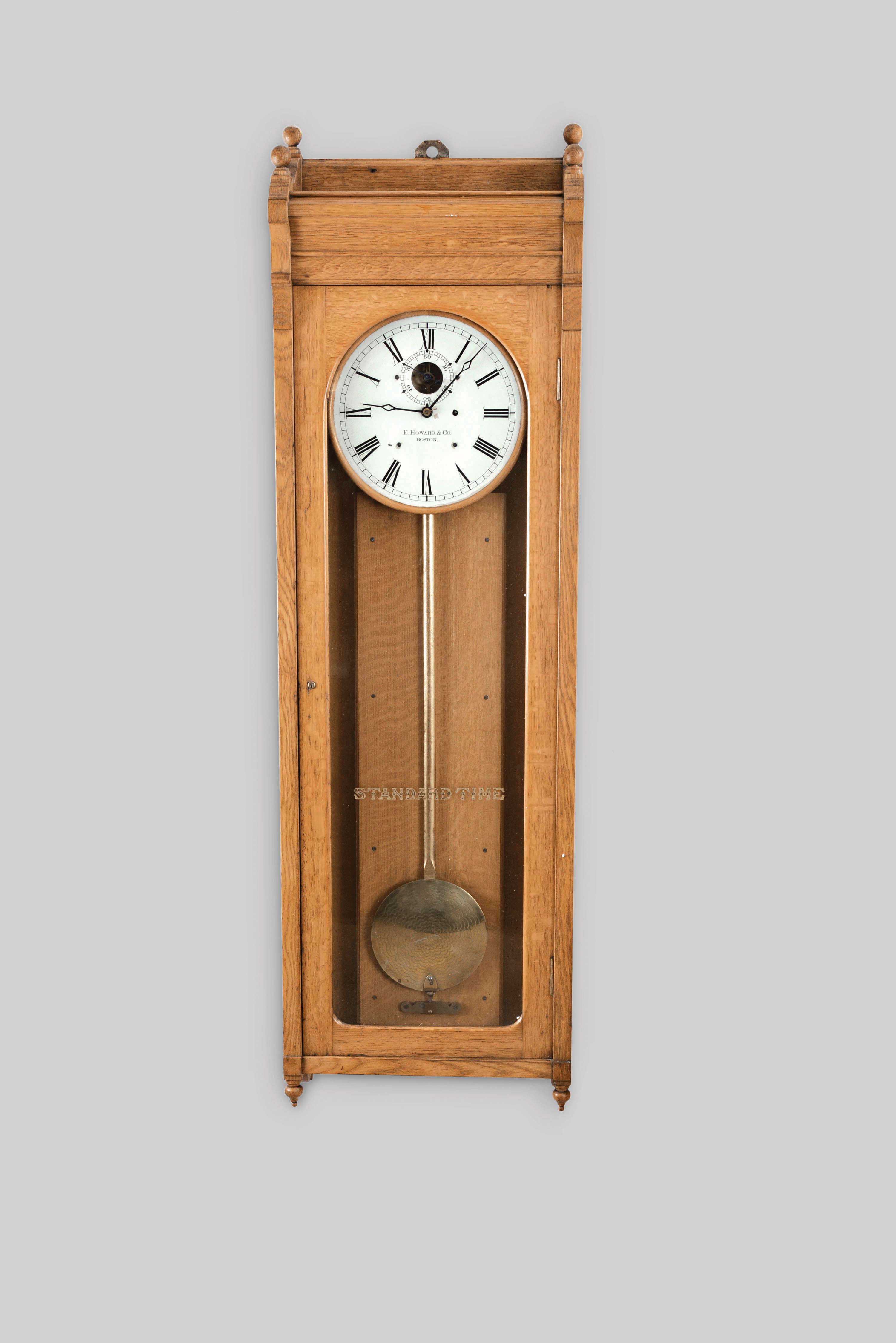 E. Howard &amp; Co., Boston, Mass., "No. 89 Regulator", wall clock, 8 day, time only, weight driven movement with damascened pendulum disc in an oak case with a painted zinc dial — Antique Clocks Price Guide
