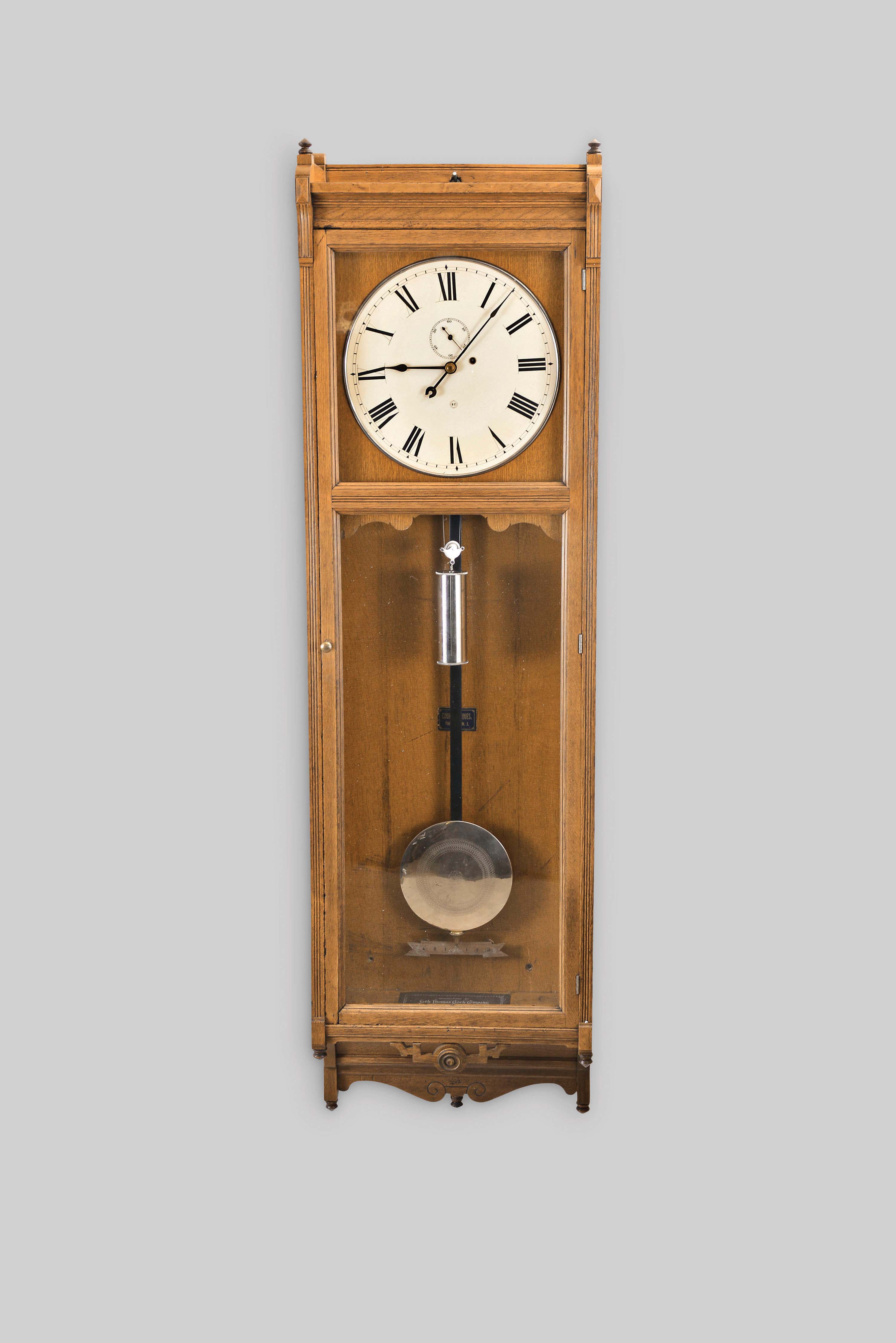 Seth Thomas Clock Co., Thomaston, Conn., "Regulator No. 17", wall clock, 8 day, time only, brass weight driven movement in an oak case with a painted metal dial — Antique Clocks Price Guide
