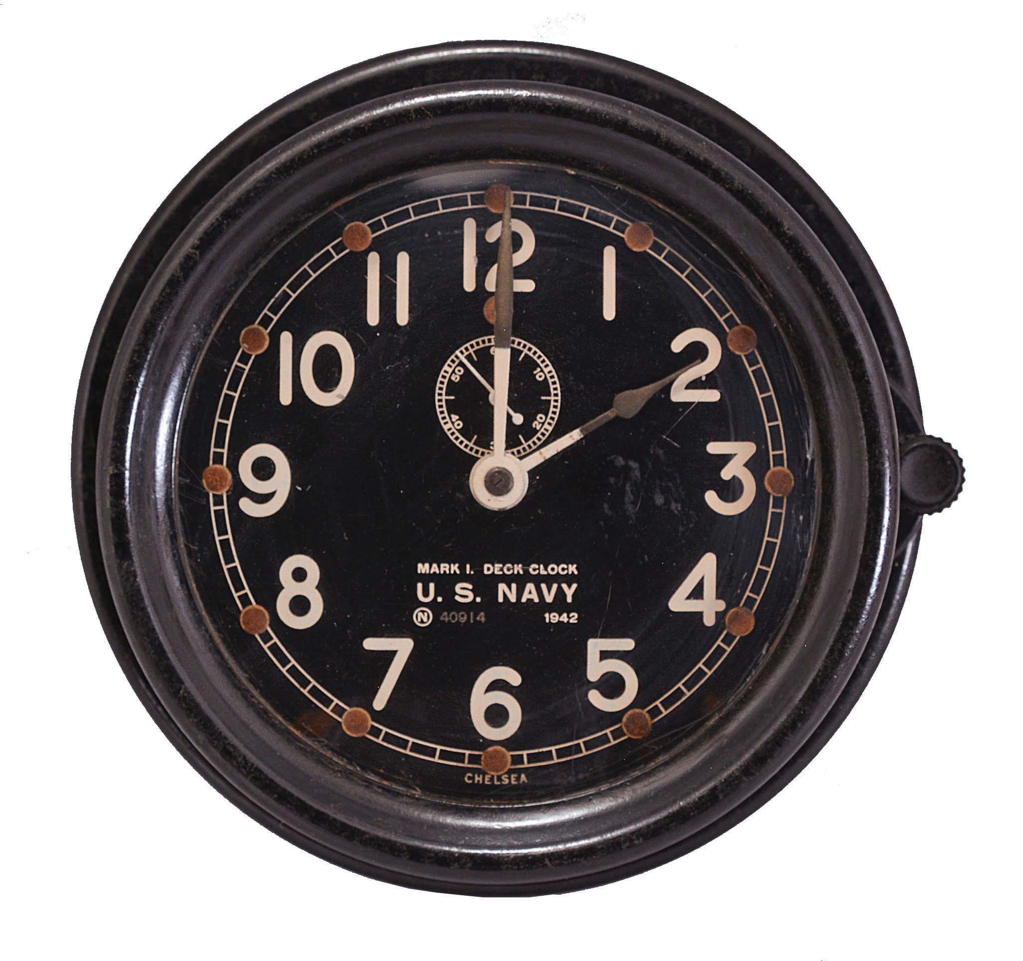 Chelsea Clock Co., Boston, Mass., "Mark I Deck Clock", 8 day, time only, spring-driven balance wheel movement with subsidiary seconds and rear wind in a black phenolic case with a 5.5 inch black dial reading in part "U.S. Navy / 1942", original wall mounting plate, serial number 392149, dated 1942. — Antique Clocks Price Guide
