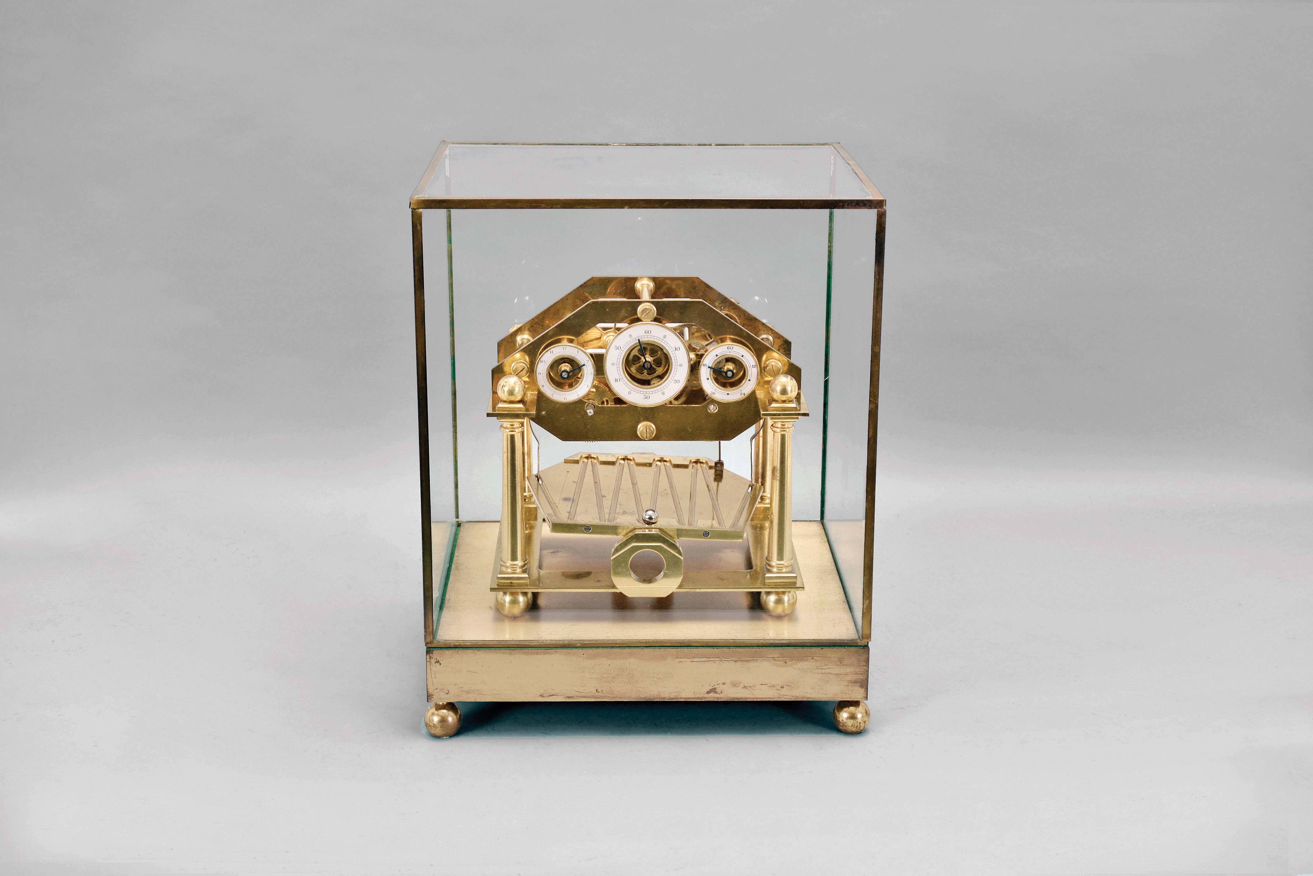 Emperor Clock Co. Ltd., London, a reproduction Congreve rolling ball timepiece, fusee movement with separate dials for minutes, hours and seconds, the plates supported by four turned columns, all resting on ball feet, the tray with zig zag path for the steel ball "oscillator" suspended below the movement, and with rectangular base, spherical leveling feet, and conforming glass dome, serial #053 from an edition of 250. — Antique Clocks Price Guide