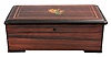 Switzerland, music box playing 4 tunes with a 3.5 inch cylinder on a comb with 44 teeth in wood case grain-painted to look like rosewood with a floral motif on the lid. Tunes include "Home Sweet Home", "Dancing in the Barn", "The Star Spangled Banner", and one other.
