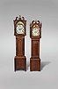 Tall Clocks- 2 (Two) England / Scotland, 8 day, time and strike, weight driven movements in broken arch topped cases with painted metal dials: (1) J.M. Gibson, Alnwick in oak; (2) R. Murray, Lauder in mahogany