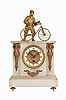 France, 8 day, time spring brass movement alabaster mantel timepiece with statue of a man and his bicycle.