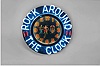 Neon gallery wall clock, "ROCK AROUND THE CLOCK", electric driven, time only movement with large 15in black dial, Arabic numerals and blue and red lighted neon perimeter displaying "ROCK AROUND THE CLOCK"