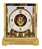 Jaeger- LeCoultre, Switzerland, "Atmos" clock, 15 jewel, caliber 528-8/6 movement, torsion pendulum, round metal dial with applied gilt arrow markers and numbers, gilt hands, all contained in a glazed rectangular case with original styrofoam packaging box, serial #220770.