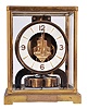Jaeger- LeCoultre, Switzerland, "Atmos" clock, 15 jewel, caliber 526-5 movement, torsion pendulum movement with round metal dial, applied gilt arrow markers and numbers, gilt hands, in a glazed rectangular case with hinged font door, original cloth-covered box, serial #106500.