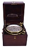 Dent, 61 Strand, London, a rare eight day marine chronometer with Dent's staple balance, 12 jewel, free sprung, reverse fusee movement with Earnshaw's escapement, bimetallic staple balance, blued steel helical balance spring and diamond endstone, Roman numeral silvered dial with wind indicator, blued steel spade and poker hands, contained in a lacquered brass bowl, and mounted in a gimballed mahogany and mahogany veneer box with brass furniture, the front with round plaque marked "3105"