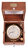 Thomas Mercer, St. Albans, two day marine chronometer, 13 jewel fusee movement with spotted plates, Earnshaw's escapement, and freesprung cut bimetallic balance with helical balance spring, Roman numeral silvered dial with wind indicator and blued steel spade and poker hands, with gimballed brass bowl, contained in a two tier mahogany box, serial #25964