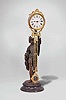 Ansonia Clock Co., New York, "Fisher" swinger shelf clock with a spring driven, 8 day, timepiece movement in a gilt and nickel cannister-style case with a bronze finished spelter statue on a black enameled iron base.