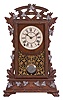 Seth Thomas Clock Co., Thomaston, Conn., "Santa Fe" shelf clock with a spring driven, 8 day, time and strike lyre movement in a walnut case with applied metal leaf decorations.