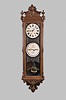 Ithaca Calendar Clock Co., Ithaca, N.Y., "No. 1 Regulator Sweep", hanging jeweler's regulator, 8 day, time with sweep seconds, perpetual calendar, double weight driven movement with a gridiron pendulum in a walnut case with carved crest and bottom with papered metal dials