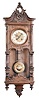 Gustav Becker, Freiburg, Germany, Vienna style wall clock, 8 day, time and strike (on a single chime rod), spring driven movement in a second Baroque style walnut case with short tapered columns and carved crest, embossed brass pendulum, cream porcelain dial and blued steel hands.