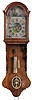 Holland, Friesland Staartklok 30 hour, time and strike, weight driven movement with alarm and endless chain driving animated farm scene in the arch driven off a pulley on the front of the escape wheel arbor, in an oak case with arch top bonnet, the pendulum aperture with stamped pewter ornament. The arcaded Roman numeral painted dial has polychrome floral corner spandrels, vignette of barn scene in center and cast brass hands, tapered weight