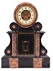 AD Mougin, Paris, mantel clock, 8 day, time and bell strike, spring-driven pendule de Paris movement with visible Brocot escapement in a black marble case with fluted red and yellow marble half columns flanking a beveled glass viewing window for the double-vial pendulum, the cream porcelain dial with Arabic numerals and matching marble surround mounted within a drum head form, the time displayed by blued steel hands.