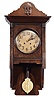 Clocks- 2 (Two): Lenzkirch, Germany: (1) Small gallery clock, 8 day, time only, spring-driven movement in a round case with molded front, Roman numeral dial, steel Breguet style hands, movement serial number 1,214,927. (2) Free-swinger with Jugendstil and Arts and Crafts influences, 8 day, time and strike, spring-driven movement in an the oak case with applied moldings and ornaments, brass embossed pendulum, Arabic numeral brass dial with blued steel hands, movement serial number 1,814,598.