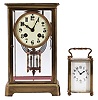 Clocks- 2 (Two) French Brass and Glass: (1) Japy Freres & Cie., Paris, crystal regulator, 8 day, time and gong strike, spring-driven pendule de Paris movement with double-vial pendulum in a glazed case with beveled glasses, gilt brass corners, top and bottom, 3.5 inch cream porcelain dial with Arabic numerals and blued steel hands. (2) France, carriage clock, 8 day, time only, spring-driven movement in a glazed case with beveled glasses on five sides, polished brass case with handle on top, white enamel dial with Arabic numerals, and blued steel spade hands.