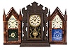 Clocks- 3 (Three) Mantel: (1) New Haven Clock Co., New Haven, Conn., sharp gothic or steeple clock, 8 day, time and strike, spring driven movement in a rosewood veneer case with a painted metal dial and silk screened door glass, blued steel hands, c1860. (2) E.N. Welch Mfg. Co., Forestville, Conn., sharp gothic or steeple clock, 8 day, time and bell strike, spring driven movement in a rosewood veneer case with a painted metal dial and silk screened door glass, maltese style hands, c1865. (3) Waterbury Clock Co., Waterbury, Conn., "Iroquois" mantel clock, 8 day, time and strike on cathedral gong, spring driven movement in a pressed oak case with a papered metal dial, silk screened door glass, and maltese hands, c1910.