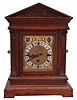 Winterhalder & Hofmeier, Schwarzenbach, Germany, bracket clock, 8 day, time and strike with Westminster chime playing on four gongs, triple fusee movement in an oak architectural case with fluted pilasters, frieze meant to resemble ashlar, tympanum with carved floral design, brass dial plate with applied cast spandrels, silvered chapter ring with Roman numerals, subsidiary rate adjustment and chime / silent dials, blued steel hands.