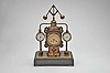 France- Andre Romain Guilmet, a rare Industrial steam boiler compendium with centrifugal governor pendulum, the stepped black slate base supporting a compass on a decorative stand, before a boiler with gilt and patinated silver surfaces and ribbed, copper base matching the clock case, the top having a cylindrical chamber with vent pipes attached to gauge form, flanking, white dialed thermometer and barometer, and concealing the helical suspension spring controlling the centrifugal governor form pendulum, Arabic numeral gilt dial, blued steel distaff hands, and 8 day pendule de Paris time and strike movement with Guilmet's mark and modifications