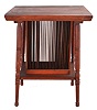 Regina music box stand in oak with turned legs, center section holding a series of vertical slats for music box disc storage, table top with beaded edge.