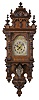 Clocks- 2 (Two) Becker Freischwingers: (1) Gustav Becker, Freiberg, Germany, free swinger wall clock, 8 day, time and gong strike, spring driven movement in an oak Altdeutsch style case with silvered dial, c1904. (2) Gustav Becker, Freiberg, Germany, 8 day, time and strike, spring driven movement in a walnut veneered Altdeutsch style case with silvered dial and fancy cast brass pendulum, c1896.
