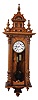 Clocks- 2 (Two) Vienna wall clocks, 8 day, time and strike, brass weight driven movement in walnut case with white enamel dial, unsigned: (1) Has embossed weights, dial center and pendulum disc; (2) Subsidiary seconds
