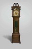 Germany, tall clock, 8 day, time and strike, brass weight driven movement in a mahogany case with broken arch top, full turned columns flanking hood door, pierced fretwork on sides, beveled trunk door glass and paw feet. The brass dial has silvered chapter ring with applied brass numerals, moon phase, and applied brass spandrels.
